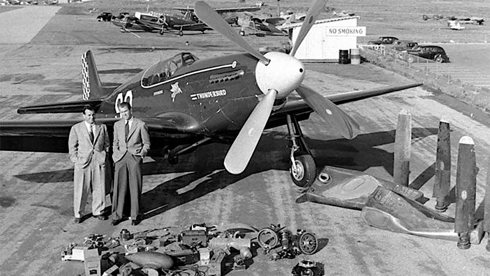 Jimmy Stewart, right, stands by the P-51 with all the parts on the ground that have been changed out.