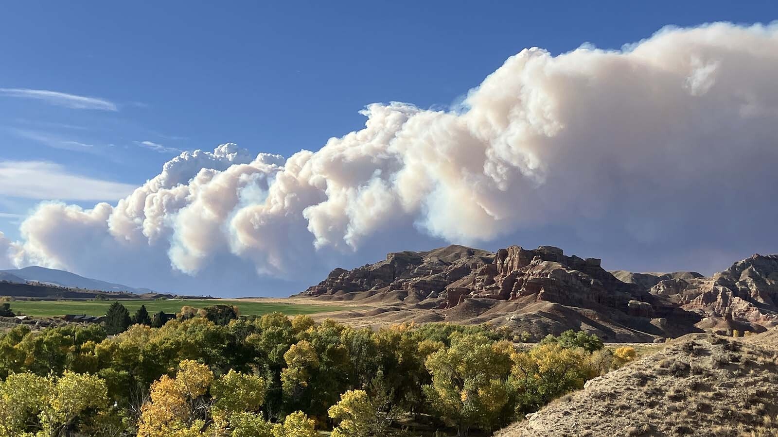 A huge plume of smoke rises up from the Pack Trail Fire near Dubois.