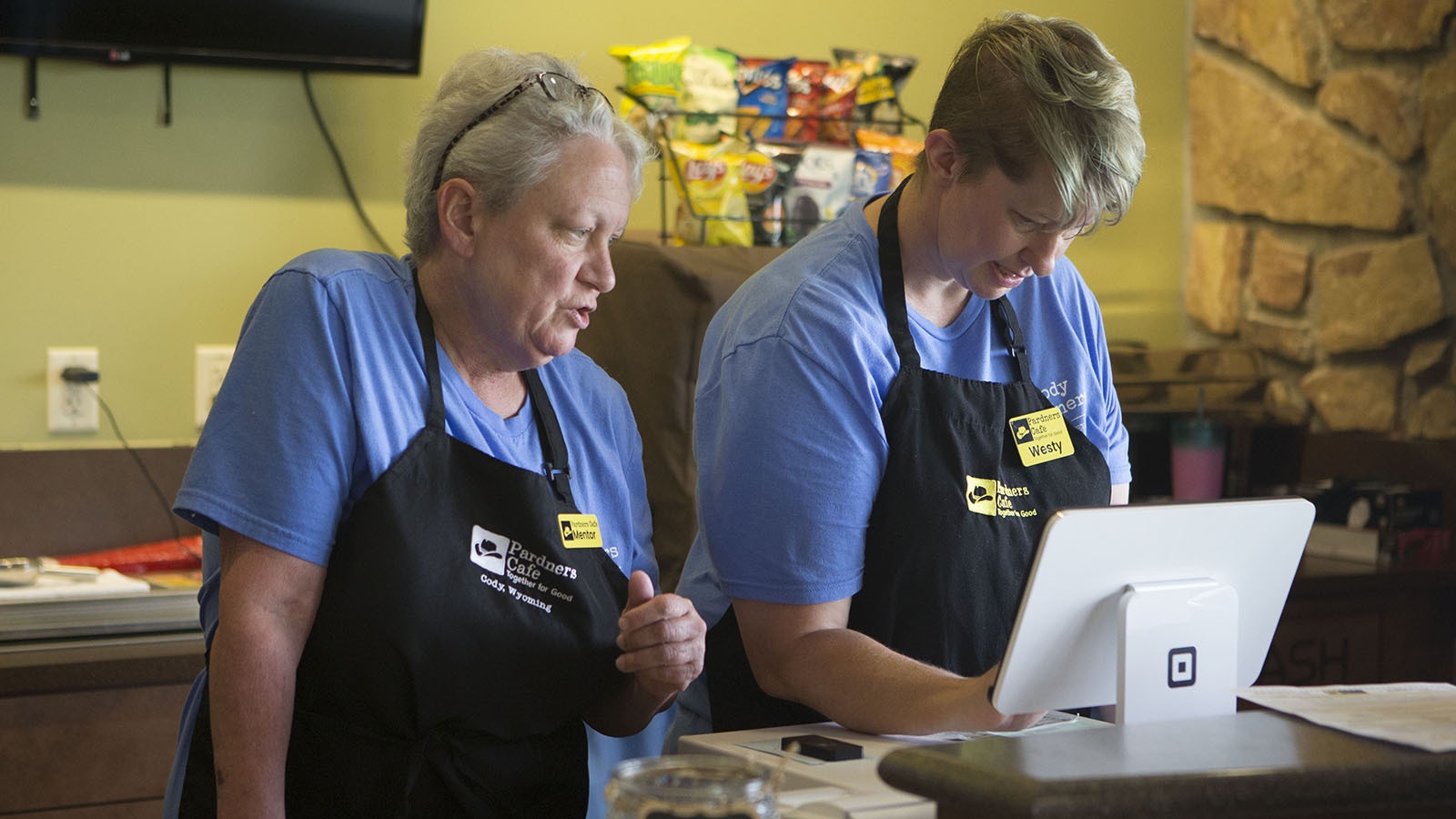 Mentor Maria Olmstead, left, works with pardner Westy Kline taking orders at the Pardners Cafe.