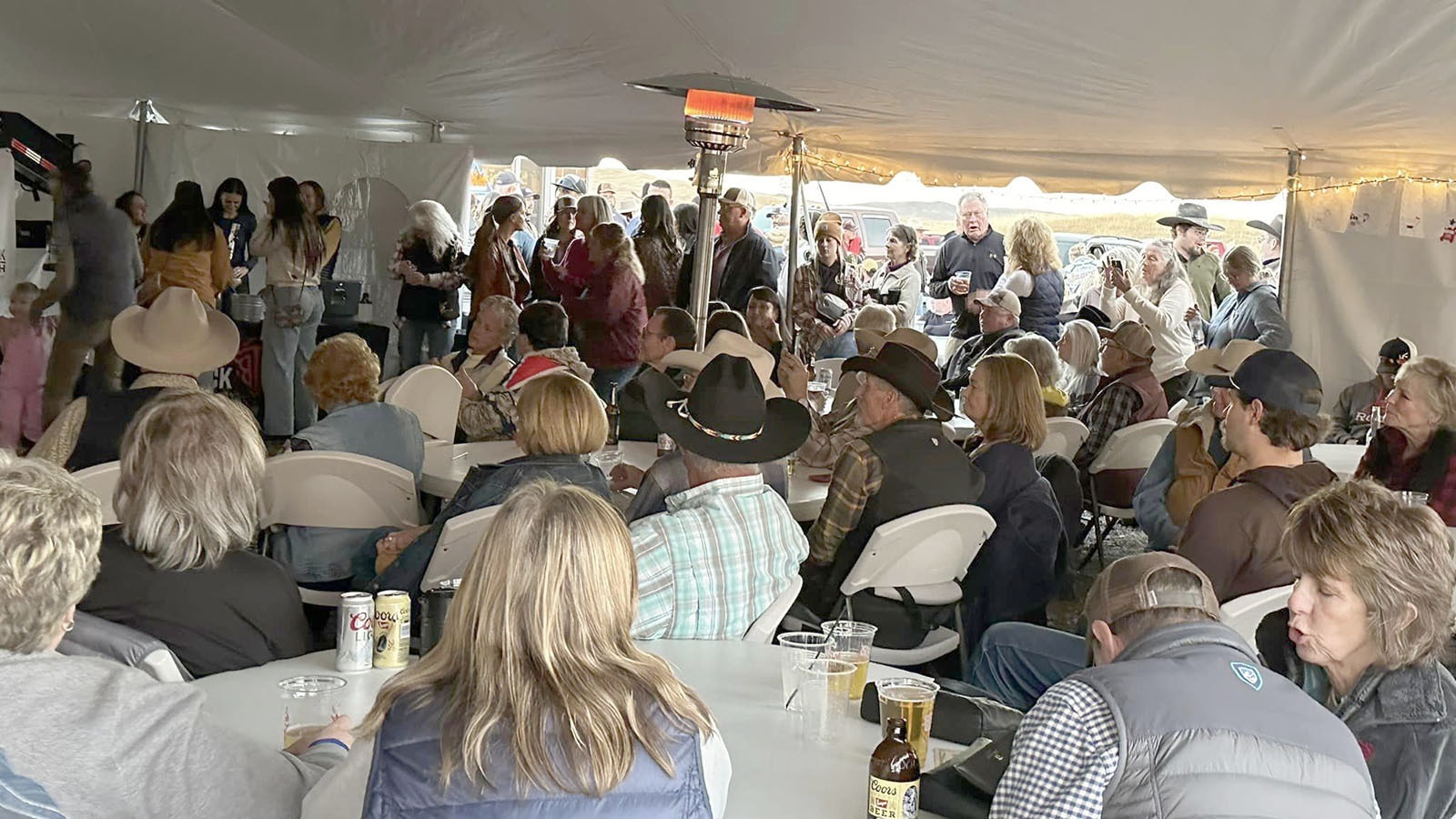 People crowded in under the tent and filled up the parking lot at the Let it Rain Concert in Parkman.