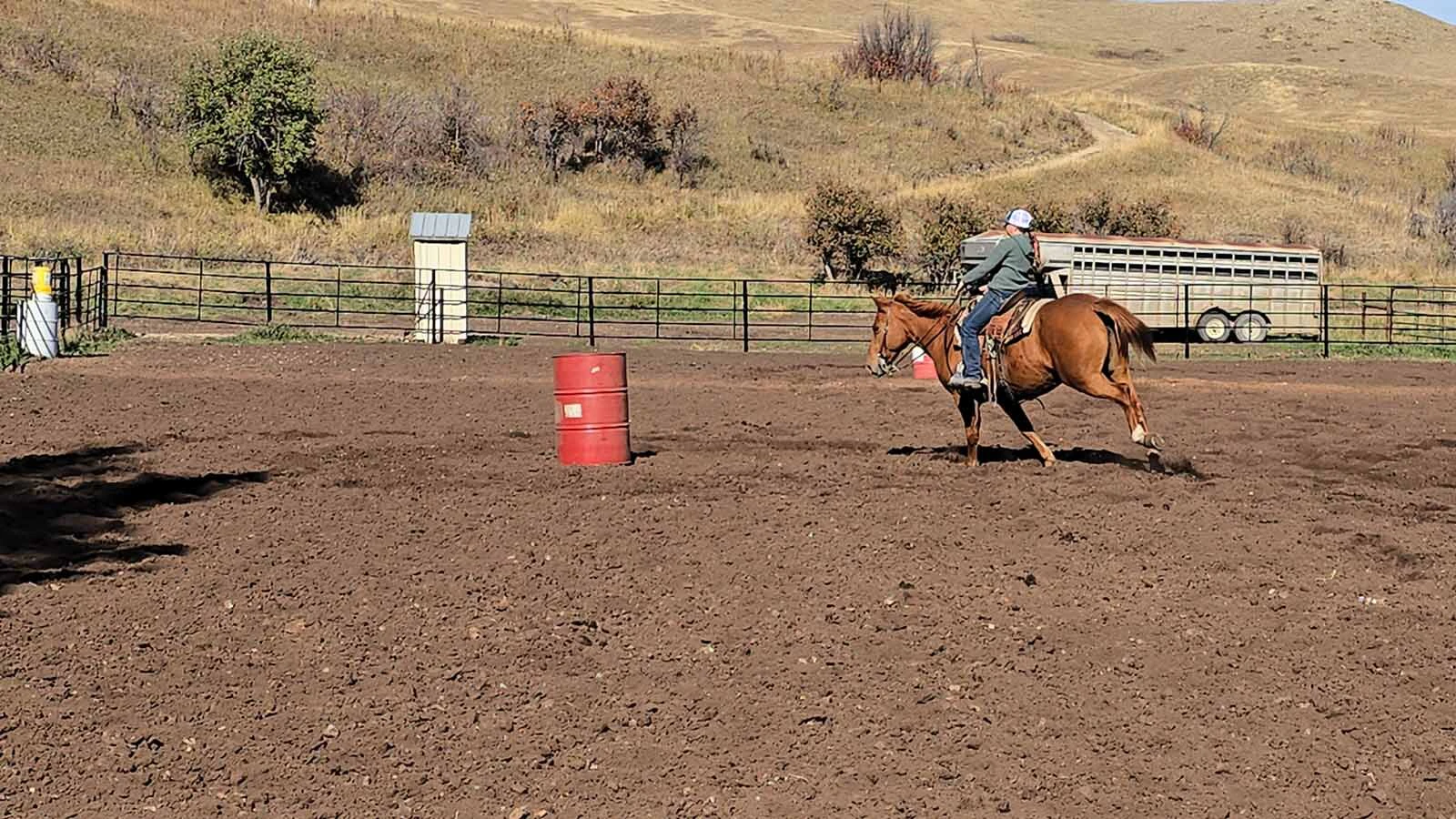 A rider makes a quick turn during the barrel races at the Double Rafter Ranch's neighborhood block party and rodeo. It was bring a dish, bring your own beverage,  and, if you have one, bring your own horse.