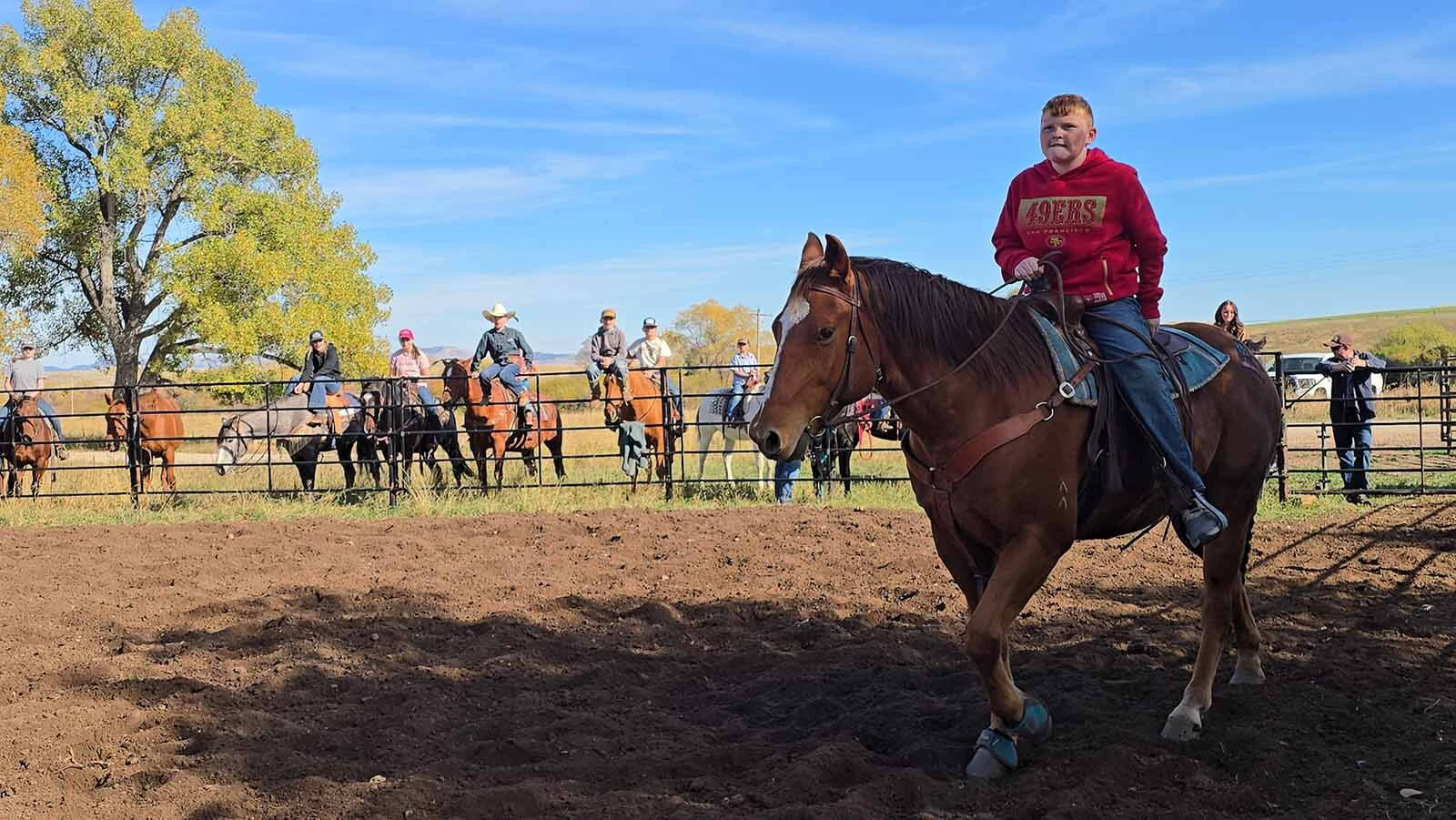 A rider enters the arena to try barrel racing at the Double Rafter Ranch's neighborhood block party and rodeo. It was bring a dish, bring your own beverage,  and, if you have one, bring your own horse.