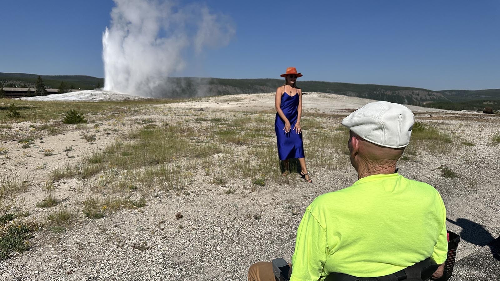 Paul Terry watches Old Faithful as someone makes a social media video nearby.