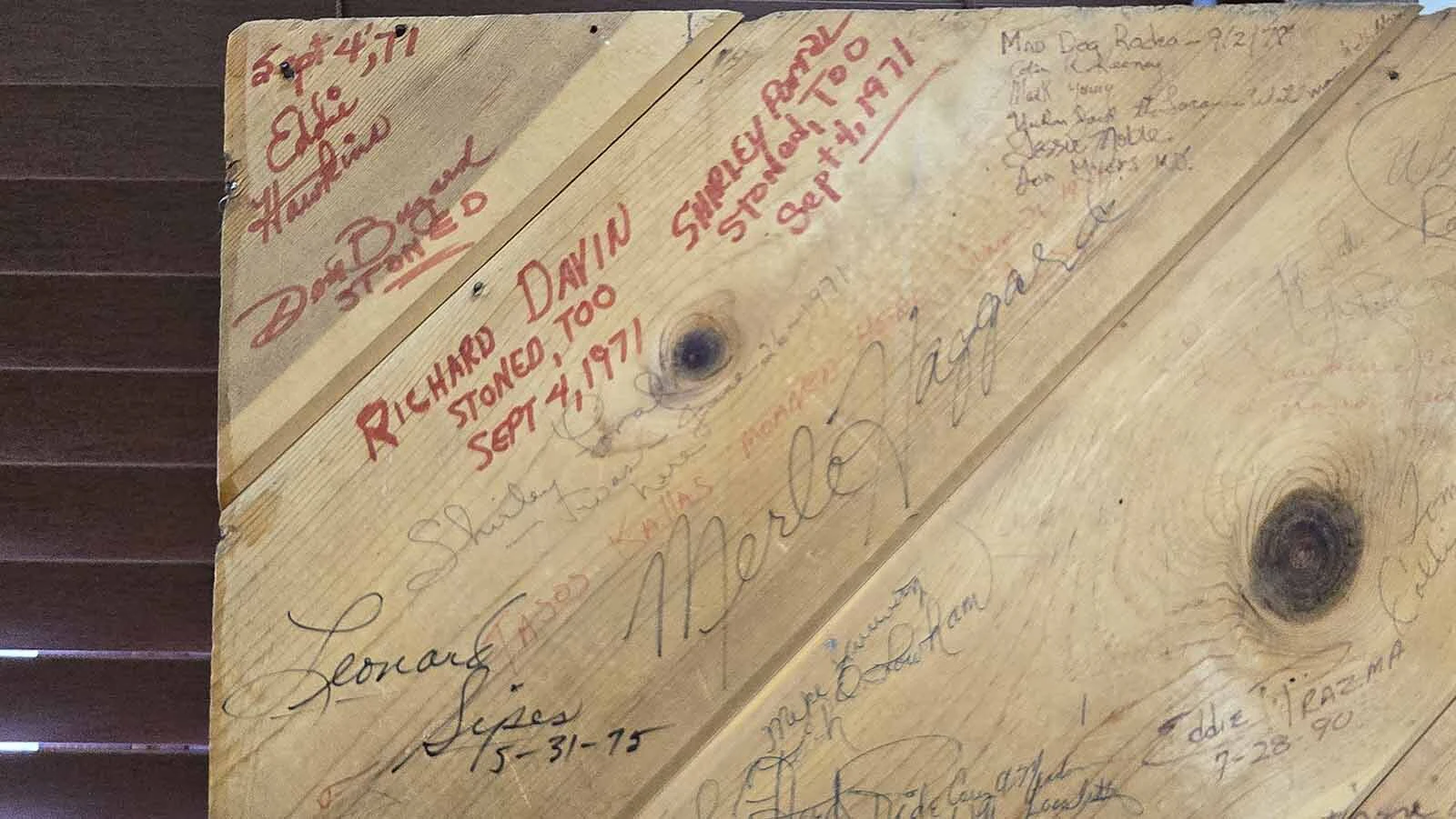 Close up of Garden Spot Pavilion door, showing signatures of many musicians, including one that says Merle Haggard.