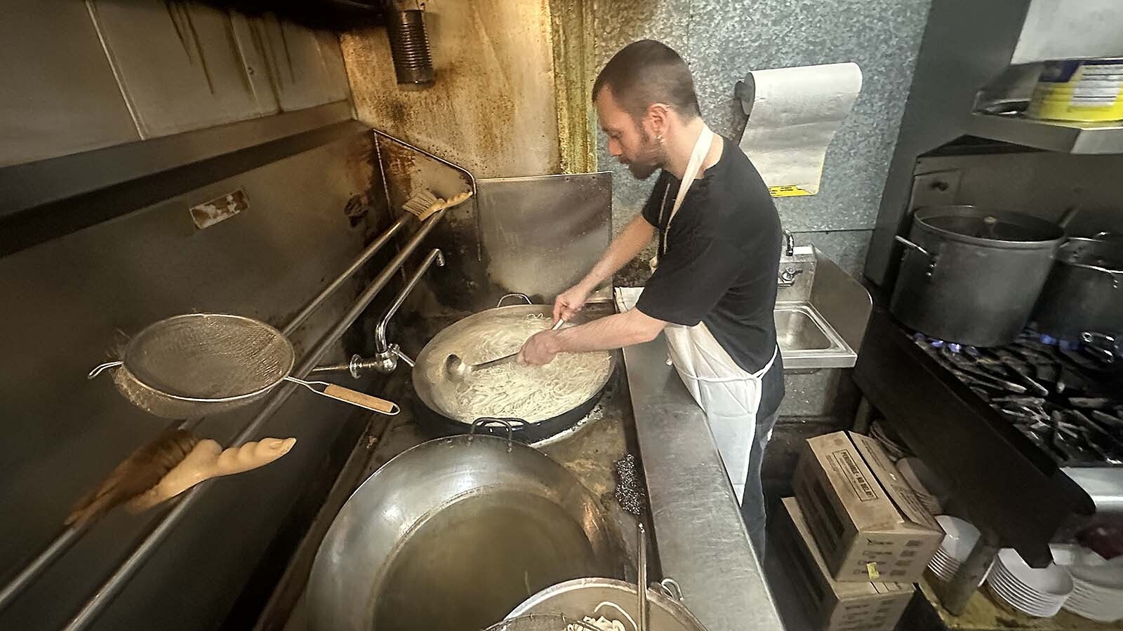 The mainstay a Pekin Noodle Parlor, Jesse Fishel pre-cooks noodles.