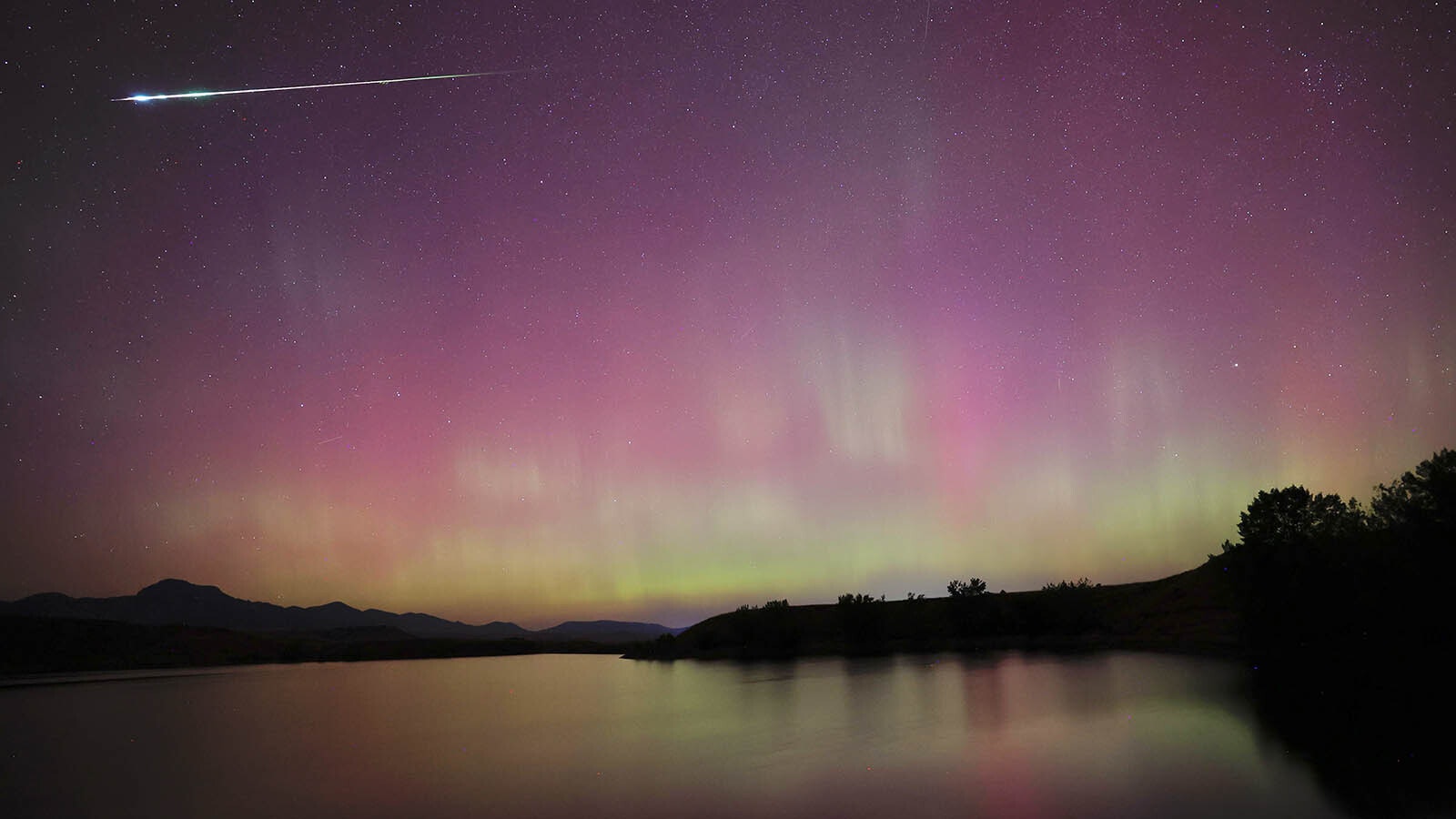 Breanna Klamm Whitlock of Buffalo, Wyoming, was shooting photos of the aurora when a bright Persieds meteor also streaked across the sky.