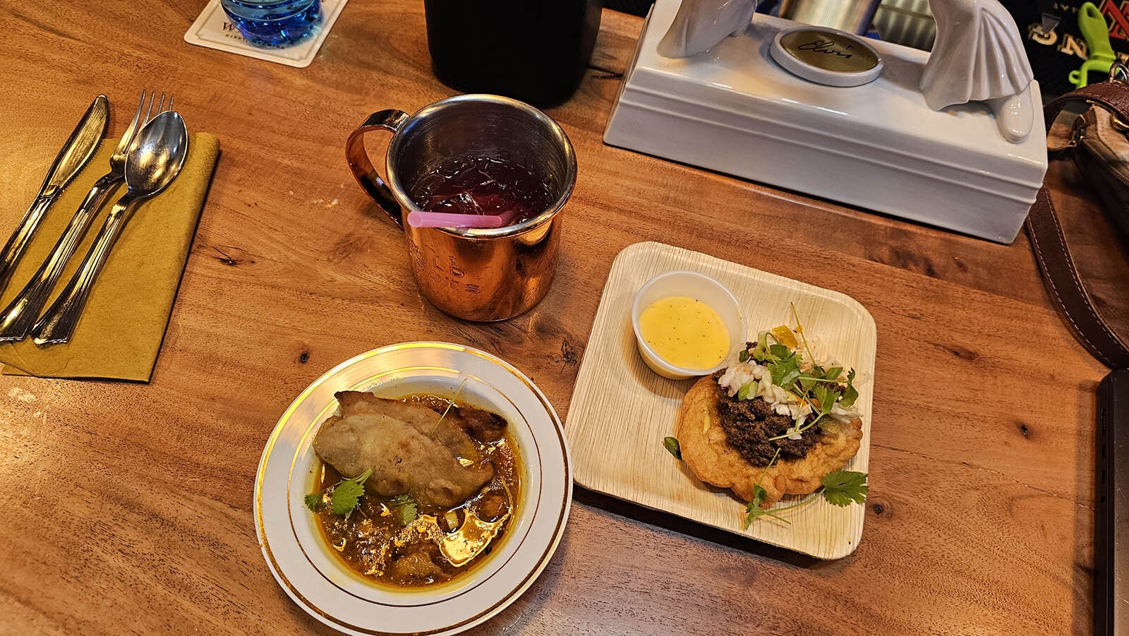 At left, chicken curry with roti by Chef Torrece "Chef T" Gregoire and at right, moose fry bread with cheese sauce by Chef Petrina Peart.