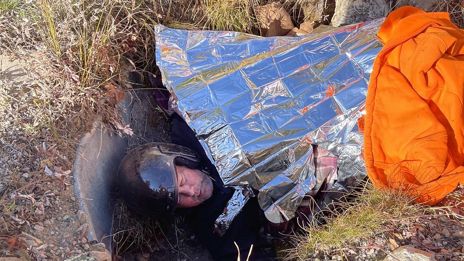 Father and son hunters Jason and Ben Koperski saved Phil Bollinger after he became stuck under his motorcycle in a culvert.