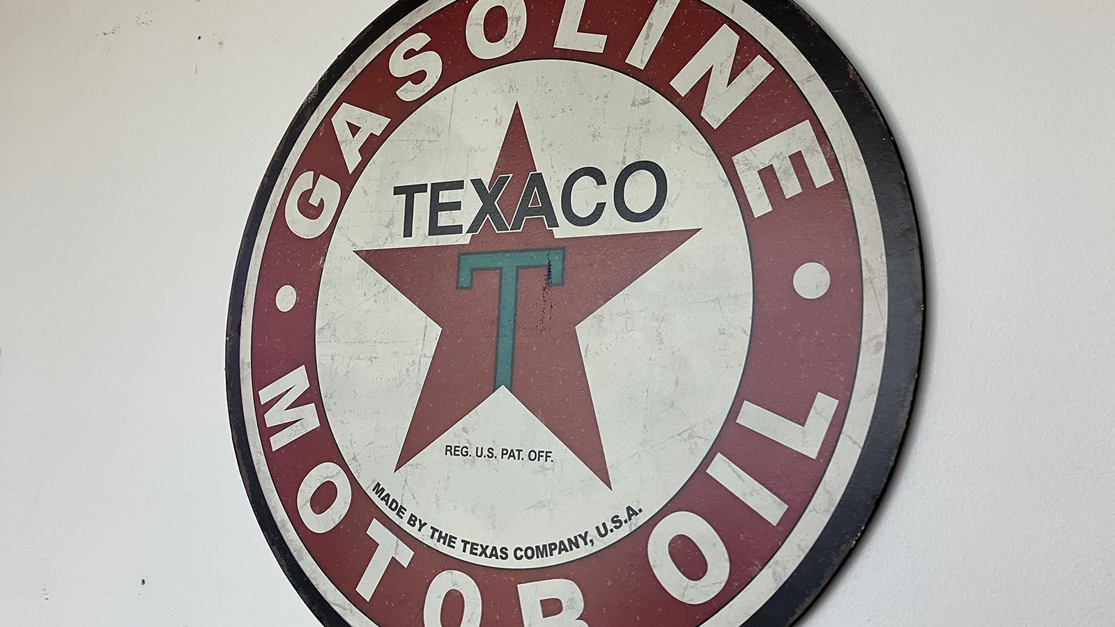 A vintage Texaco Motor Oil sign.