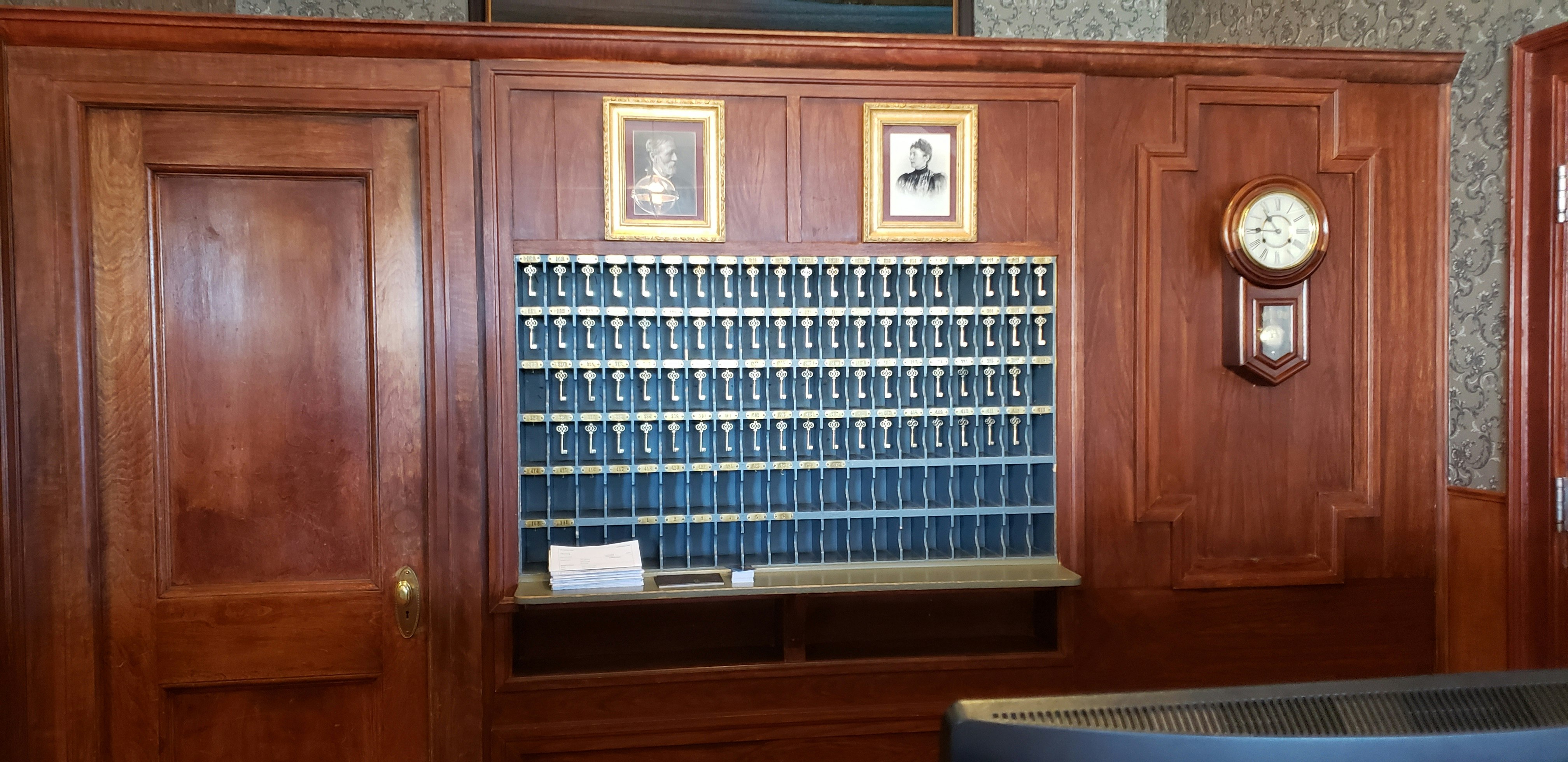 Photos of Freelan Oscar Stanley and his wife Flora in The Stanley Hotel above replicas of the original hotel room keys