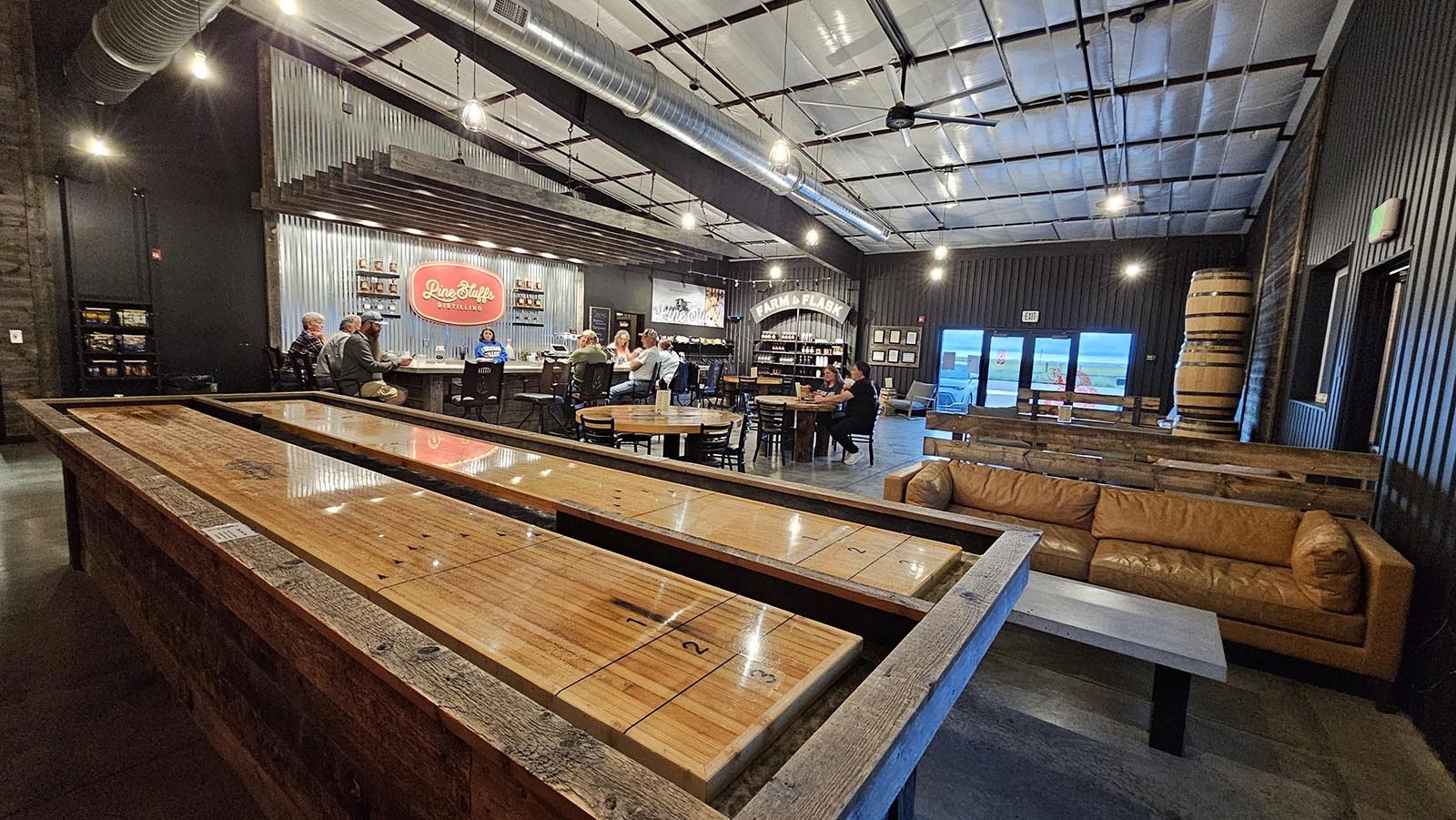 Pine Bluffs Distilling's tasting room is huge, with large, comfortable sofas, a shuffleboard game and a bar area.