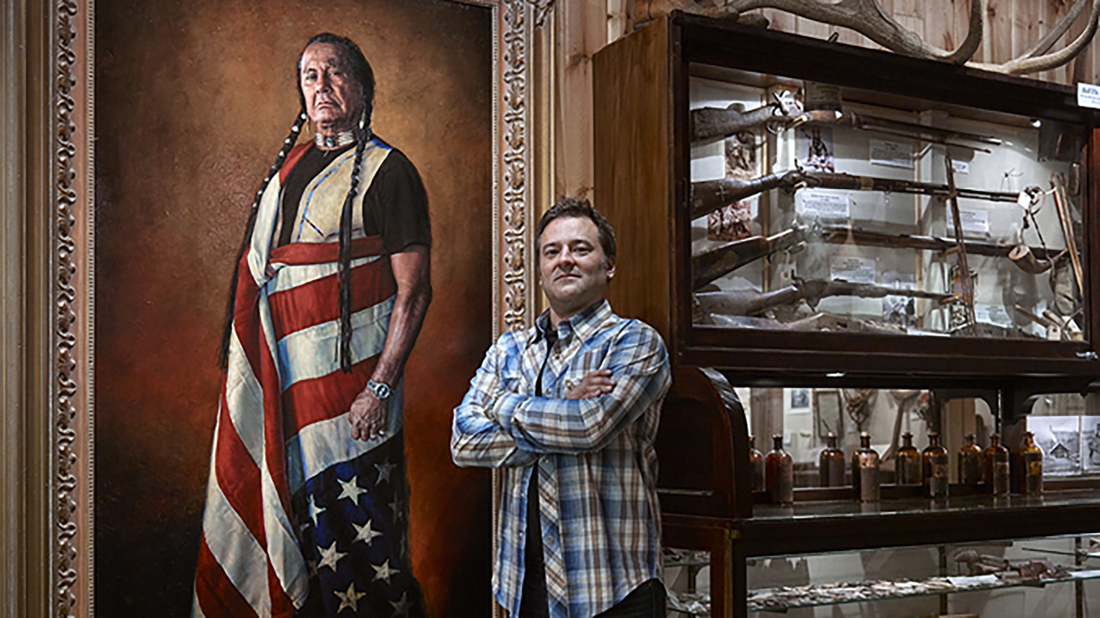 Bob Coronato poses for a Library of Congress photo in front of his painting of Indian activist Russell Means that now hangs at the Smithsonian National Portrait Gallery in Washington, D.C. The photo was taken by Carol Highsmith.