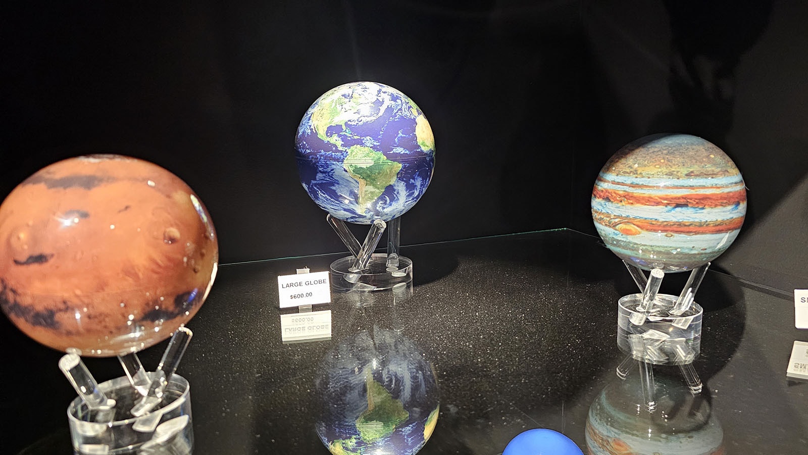 The souvenir shop has spinning balls hat replicate Earth, Mars and Jupiter.