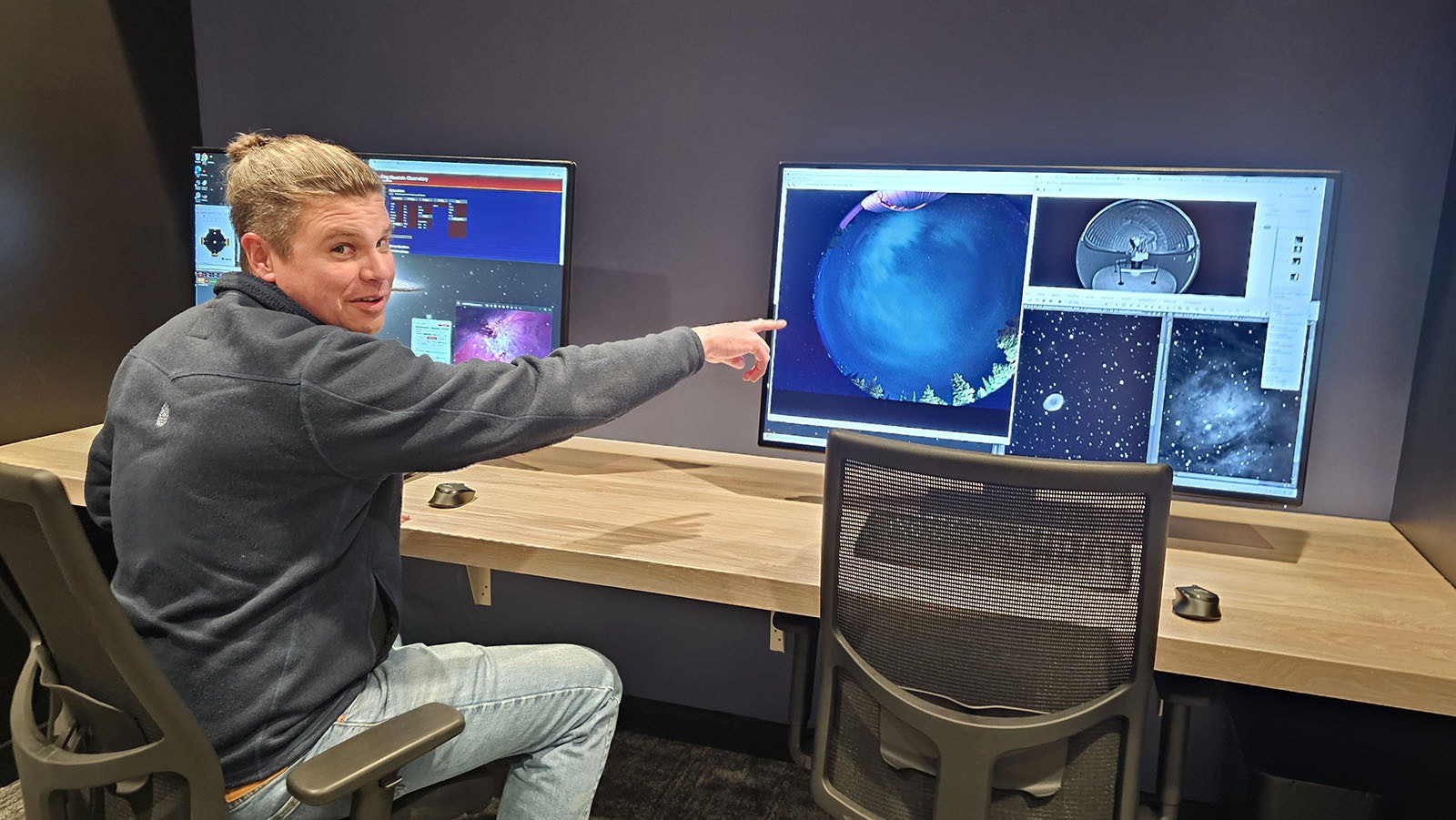 Planetarium Director Joe Zator points to a computer screen that captures in real time images as seen by its 1-meter telescope.