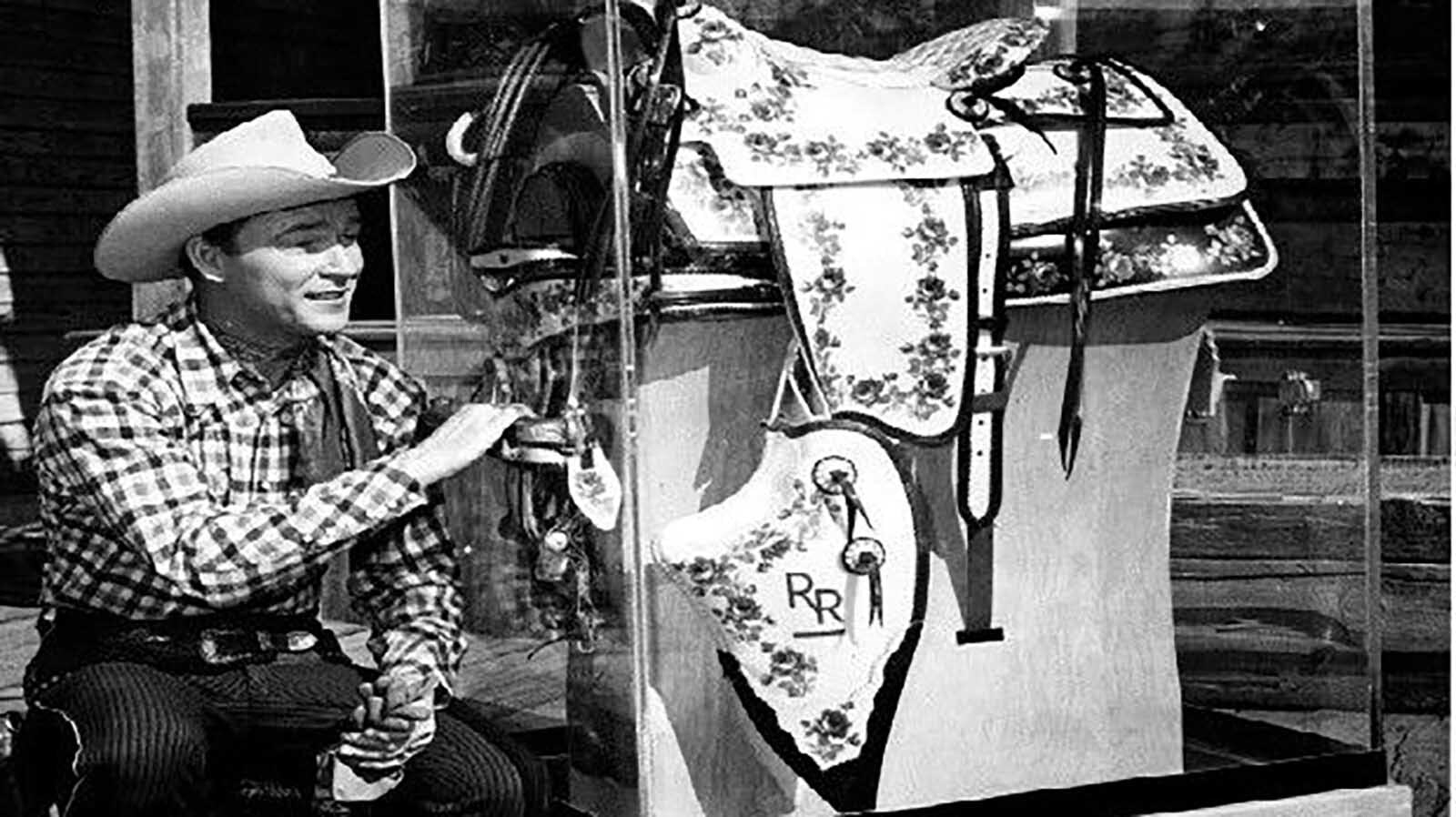 Roy Rogers poses with one of his plastic saddles. As a showman, he loved the bright vibrant colors and became a spokesman for the plastic company in Lusk that made the unique saddle.