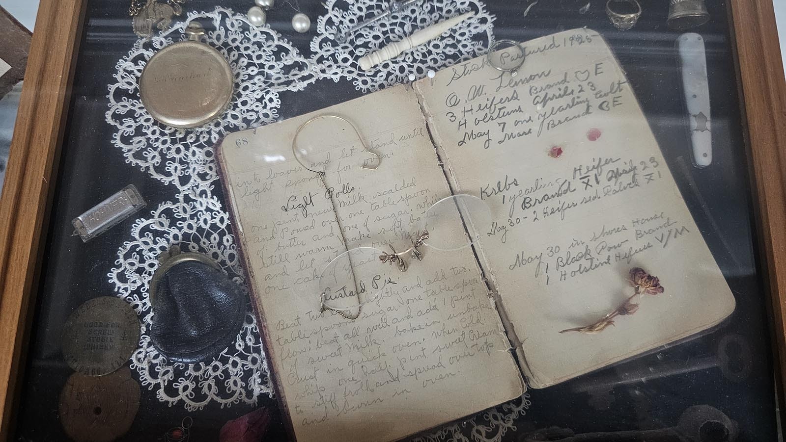 An old 1920s notebook, with business notes and recipes for Light Rolls and Custard Pie.