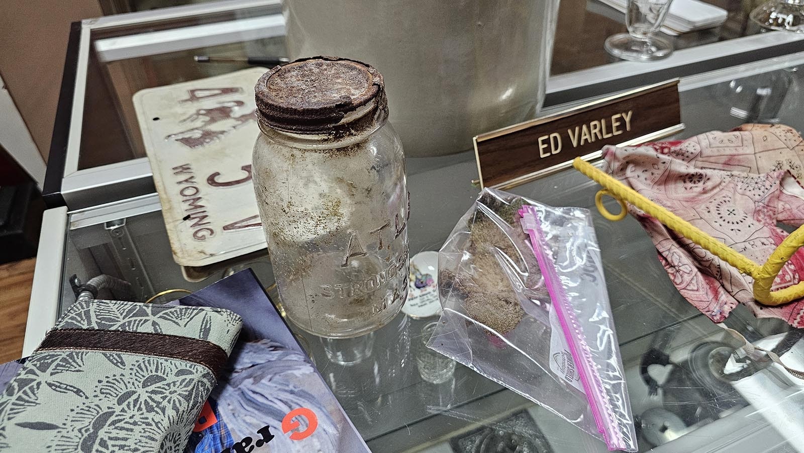 This empty mason jar and the piece of rawhide in the plastic baggy were also discovered in the same cave with the saddle.