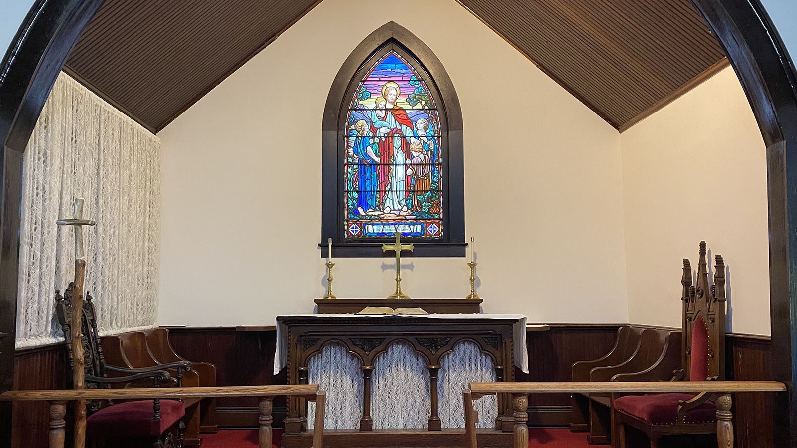 The stained glass window in front of the altar is dedicated to Dr. Frances Lane and features Jesus and the little children.