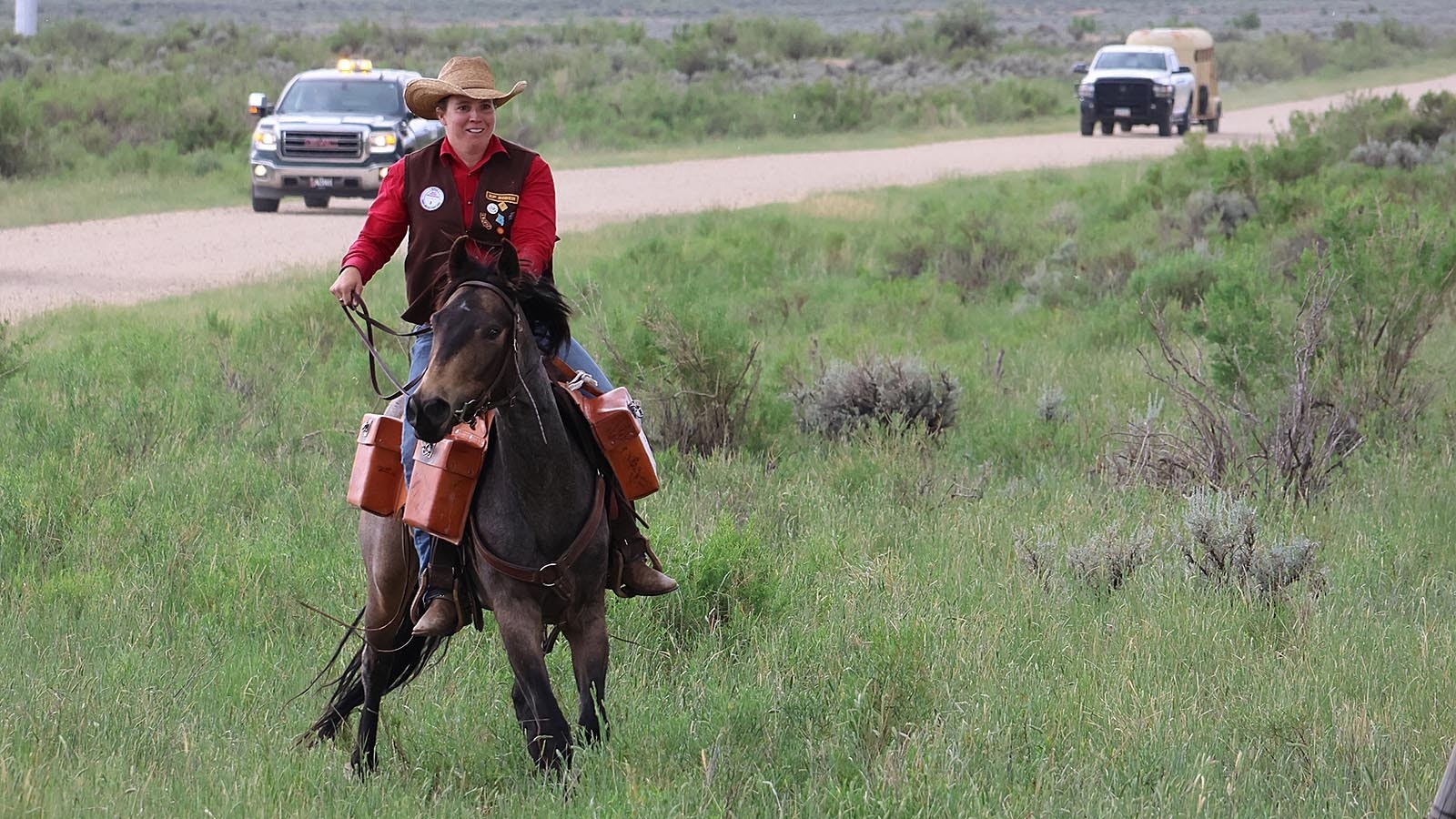 A rider navigates through a gate next to a cattle guard on Oregon Trail Road west of Casper.