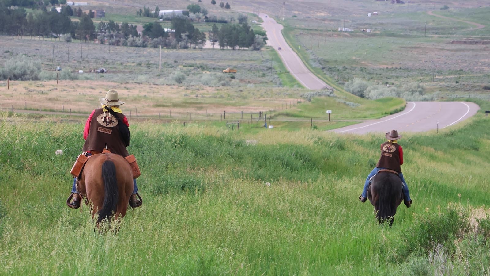 B.J. Largent, left, and Jackie Breed head down West Poison Spider Road Tuesday afternoon as part of the Wyoming Pony Express Association’s Central Wyoming Division’s effort to deliver the mail.