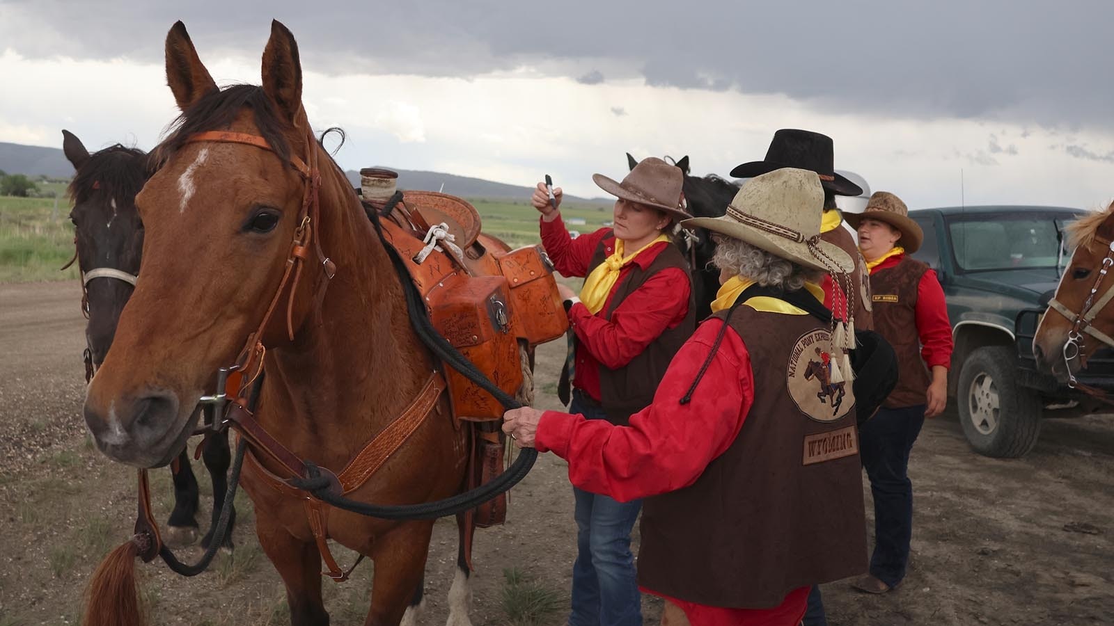 Jackie Breed signs the mochila before she and B. J. Largent carry it along Poison Spider Road in Natrona County on Tuesday afternoon.