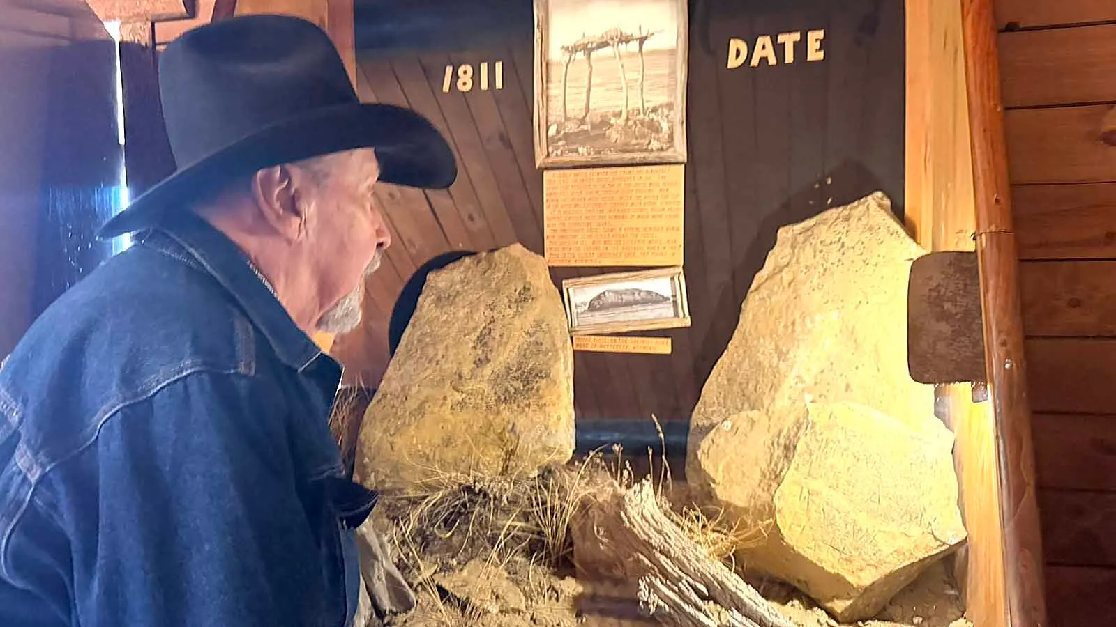 Artist and historian Larry Edgar examines the mysterious 1811 stones from Pappy-Po Butte at Old Trail Town in Cody. Edgar and his brother Bob Edgar investigated the butte after the first inscribed stone was found in 1978. Bob believed that the weathered sandstone inscriptions provide tantalizing physical evidence behind a much older local story of a battle on the butte.