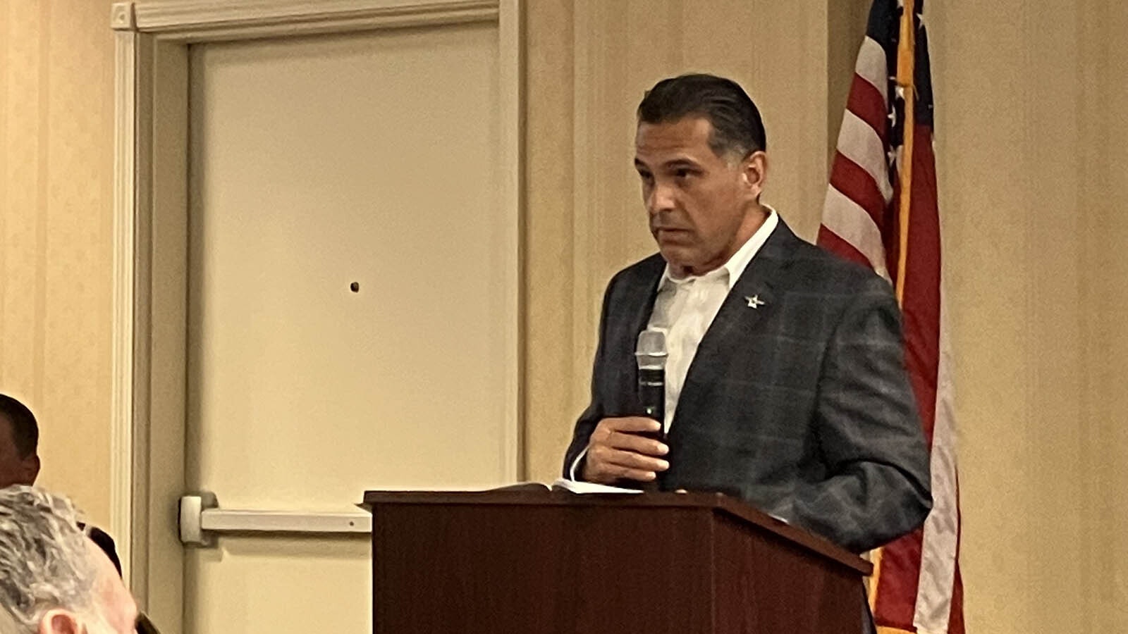 U.S. Postal Services Director for Western Processing Operations Felipe Flores addresses the crowd on Wednesday. He faced many skeptics.