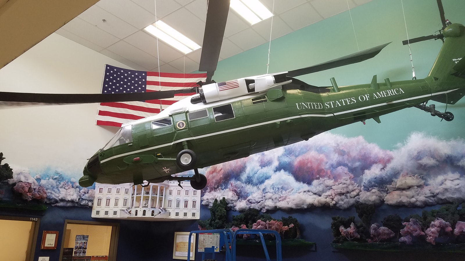 A UH 60 Black Hawk with a replica of the White House sits in one display area.