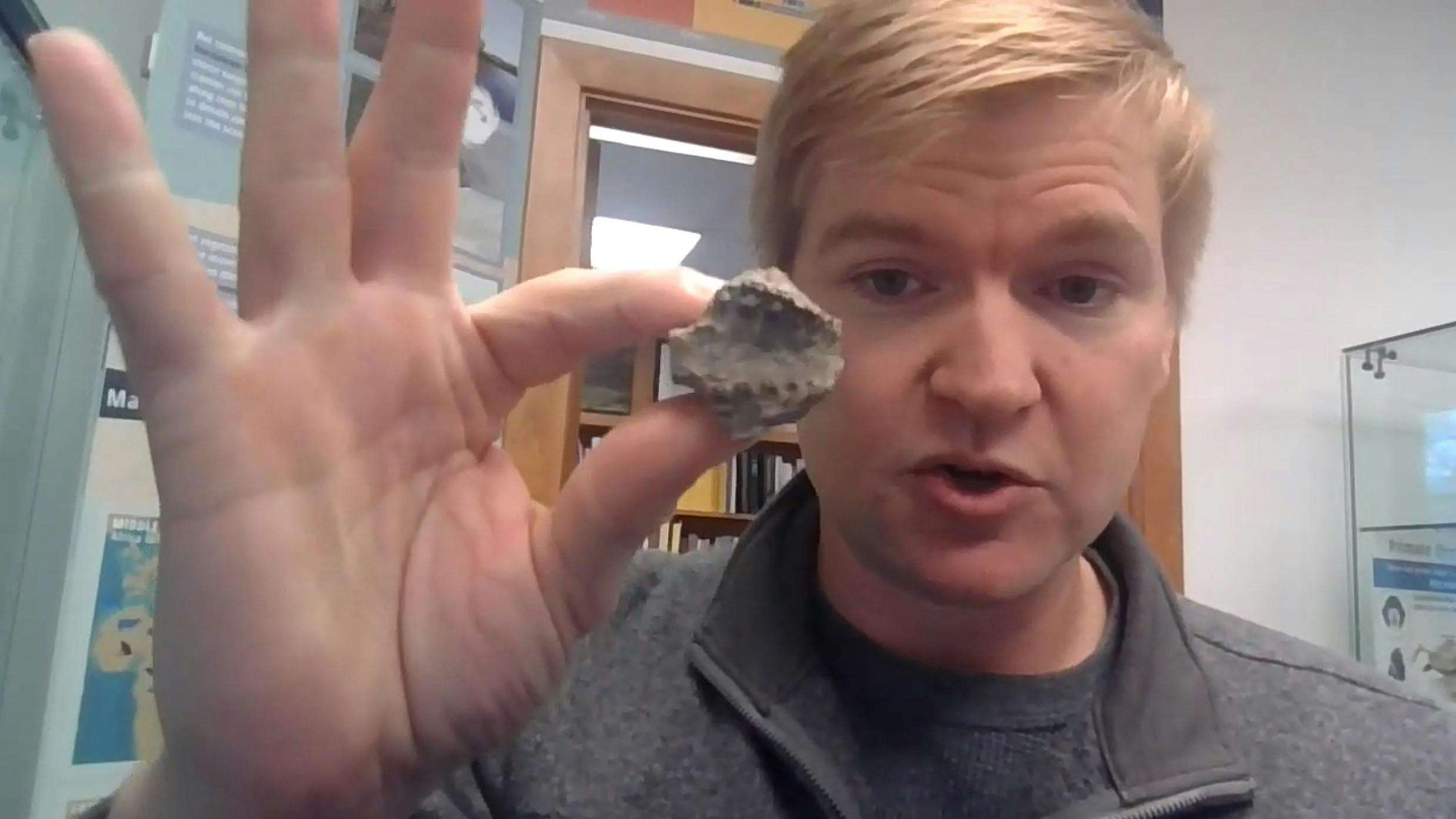 Matt Borths shows off one of the larger fossils recovered from the Eocene rocks of southwest Wyoming. This is the palette of an early primate called Cantius.