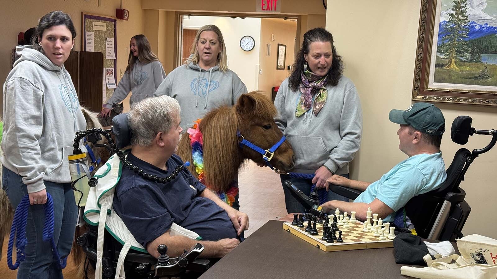 Norman the pony weighs in on an in-progress chess game at the Long Term Care Facility at Cody Regional Health.