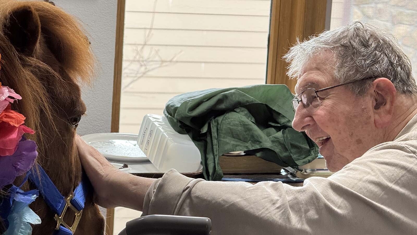 Norman the pony gets a happy welcome from one of the residents of the Long Term Care Facility at Cody Regional Health.