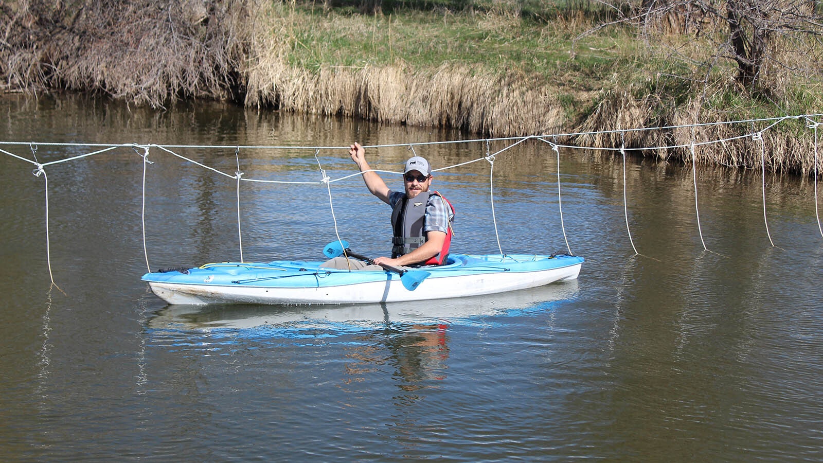 Jared Koenig, the director of recreation with the Sheridan Community Land Trust, demonstrates a “floater-friendly fence” that could help curb conflicts between ranchers and river recreationalists.