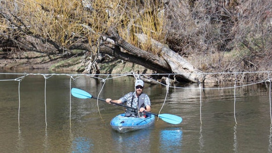 Jared Koenig, the director of recreation with the Sheridan Community Land Trust, demonstrates a “floater-friendly fence” that could help curb conflicts between ranchers and river recreationalists.