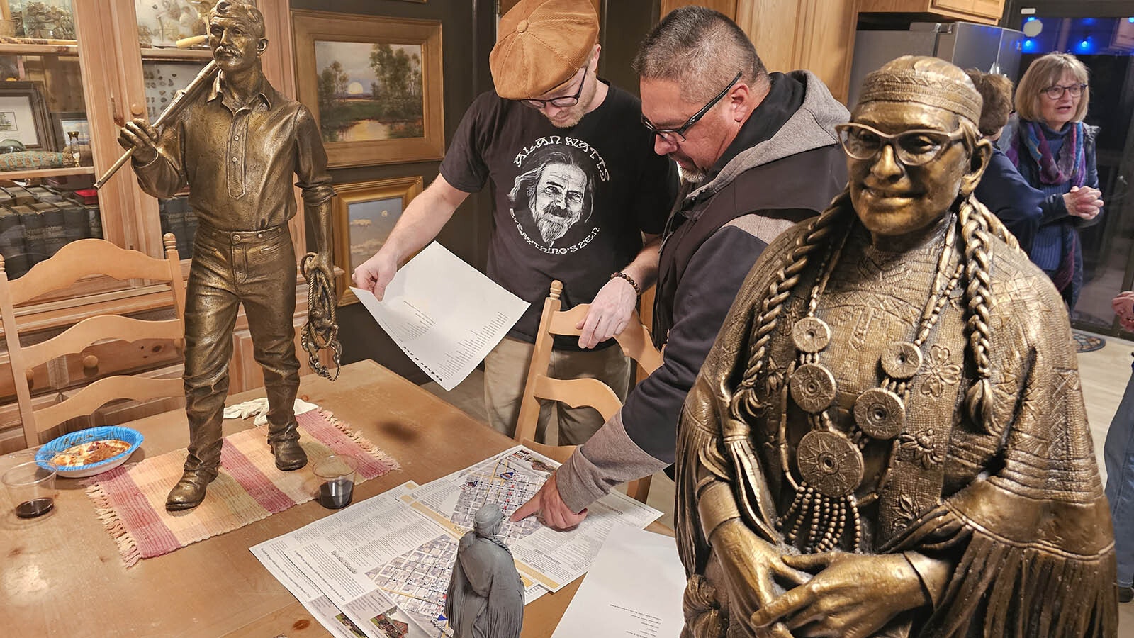 A bronze sculpture of Princess Blue Water wears a smile and her intricate bead dress while Dan Morris, left, discusses the future location of the statue with artist Joey Bainer.
