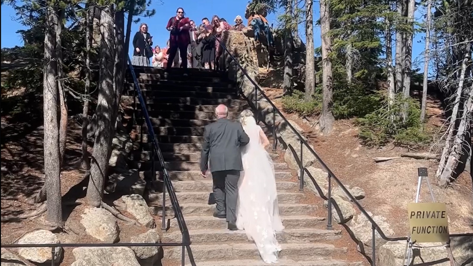 A "Private Function" sign at the stairs leading to Artist Point at the Lower Falls of the Grand Canyon of the Yellowstone is a message that, although it's a public place, the wedding party wants the space all to themselves.