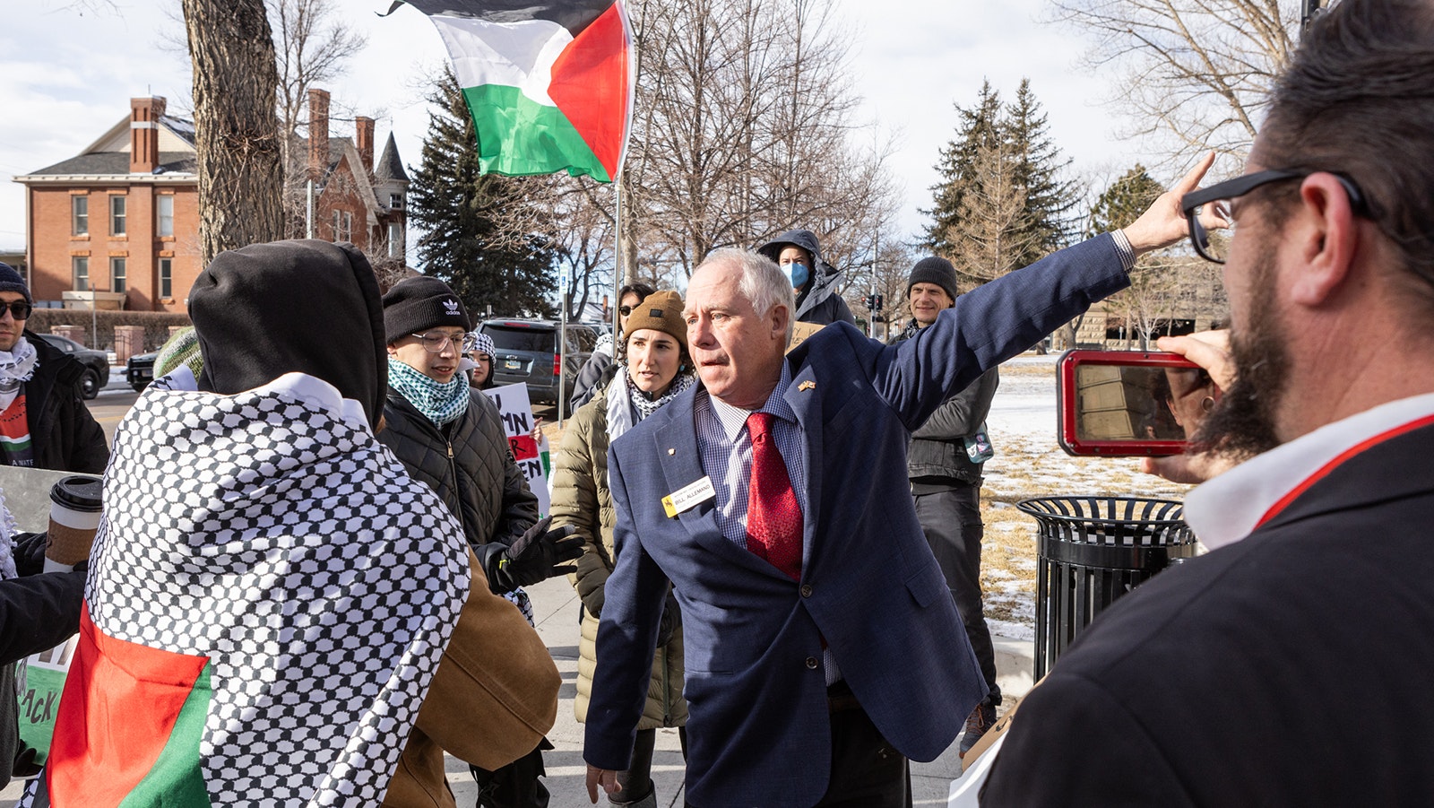 State Rep. Bill Allemand, R-Midwest, talks with a small group of pro-Palestine protesters gathered at the Wyoming State Capitol on Monday.