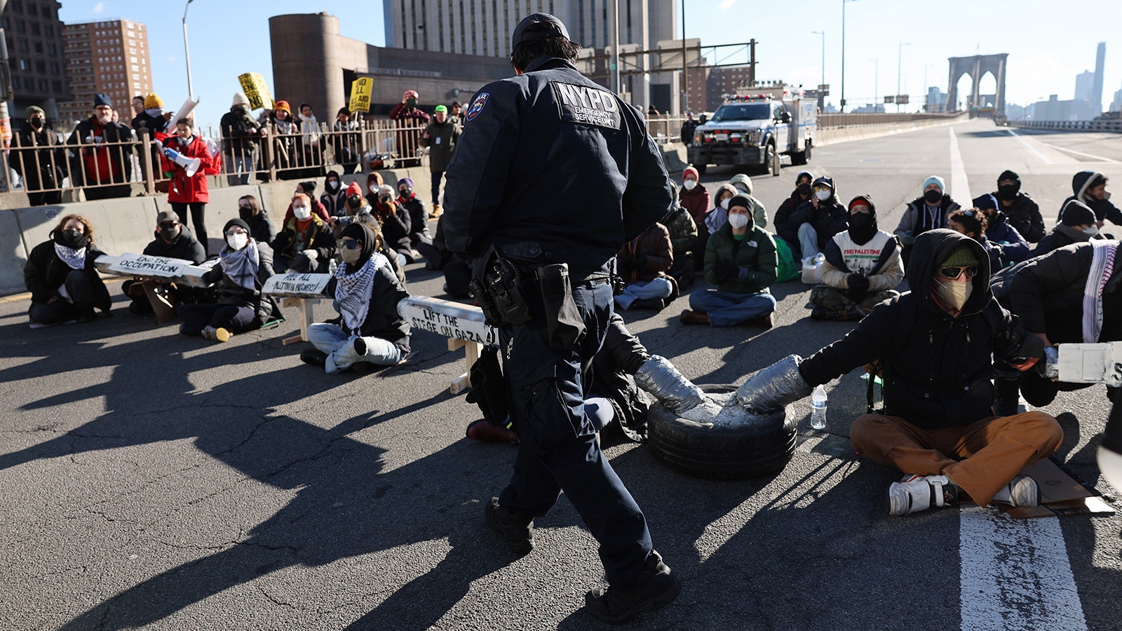 Pro-Palestinian demonstrators close down the Brooklyn Bridge, one of the main bridges connecting Manhattan to Brooklyn, on Monday morning in New York City.