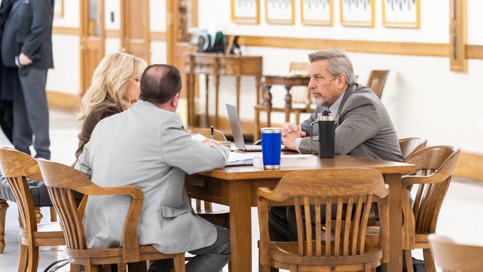 State Rep. Tony Locke, right, talks with staff from the Wyoming Department of Revenue before a committee meeting to debate property tax relief bills.