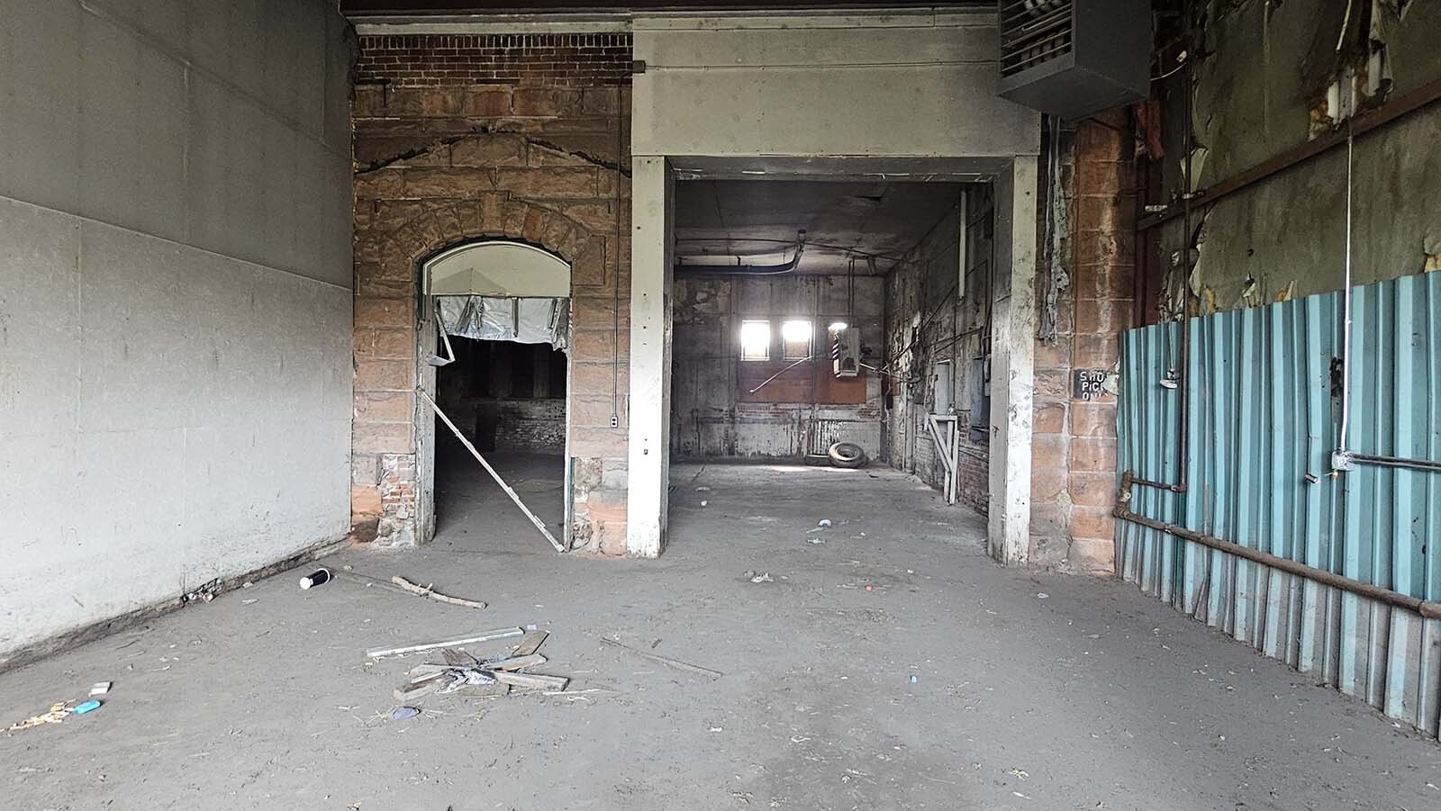 The debris on the floor is new, since the last cleaning three weeks ago. It's brought in by homeless people who climb the fence and break in the windows for a place to stay at night.