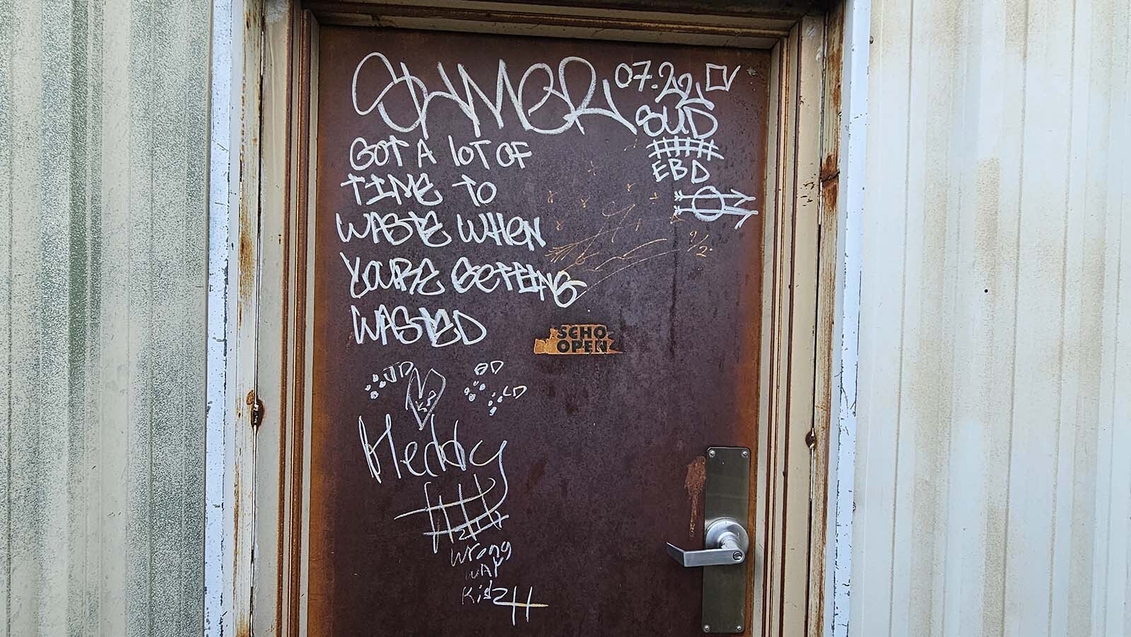 Graffiti written on the front door to the Historic Pumphouse in Cheyenne.