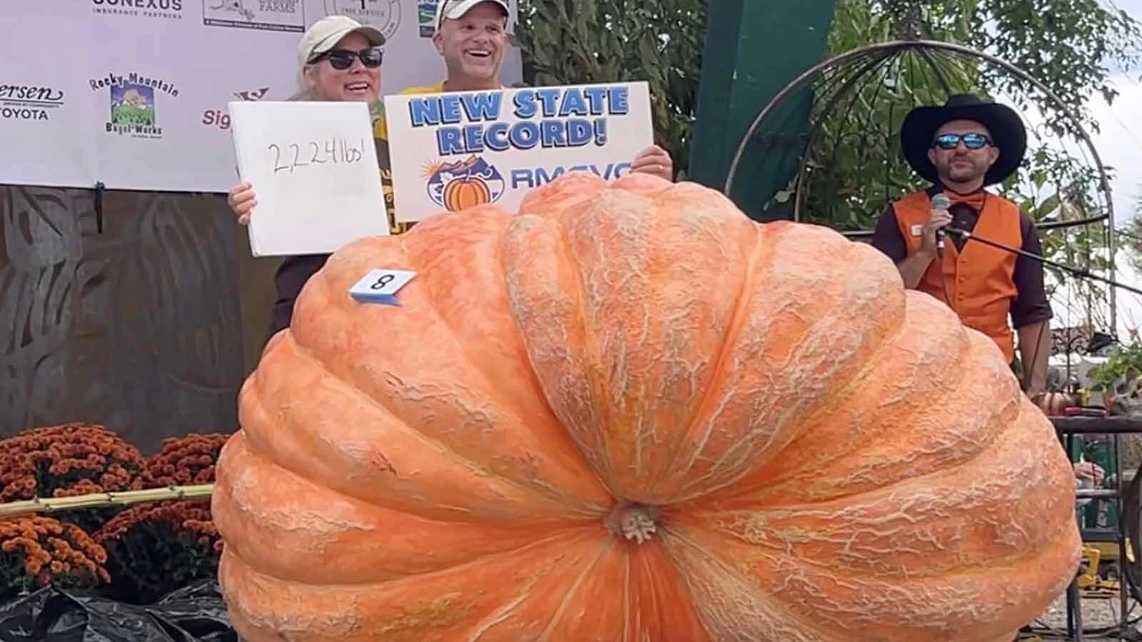 Andy and Amy Corbin pose with their Wyoming state-record 2,224-pound pumpkin at the 2026 Annual Pumpkin Weigh-Off on Saturday in Fort Collins, Colorado.