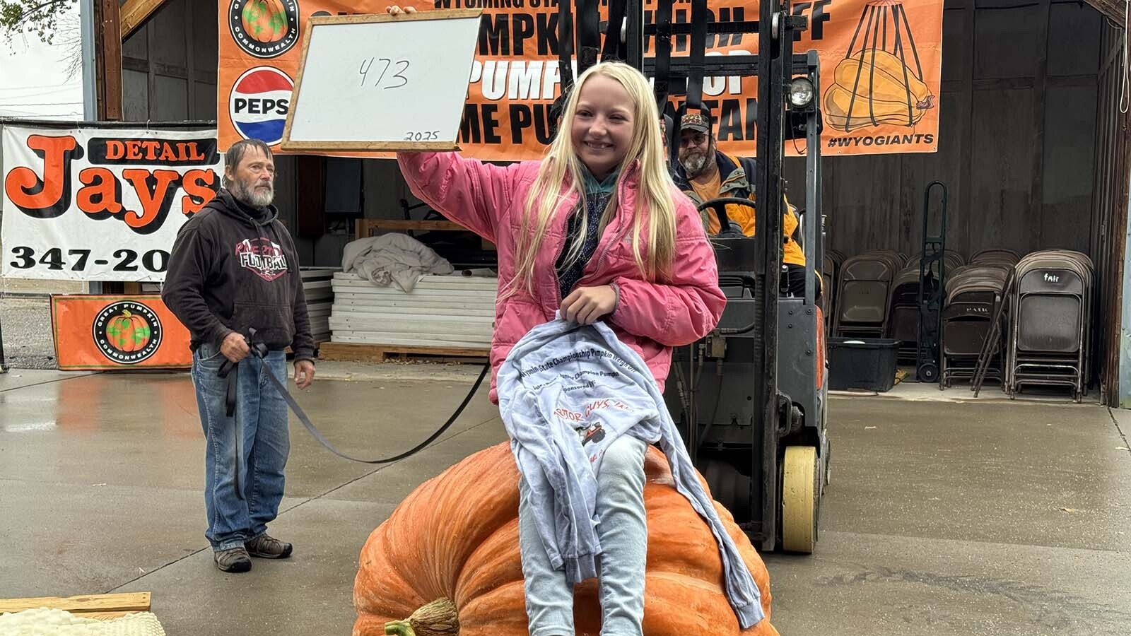Joley Reed sits atop her 473-pound pumpkin during the 2025 Wyoming Weigh-Off and Pumpkin Drop in Worland.