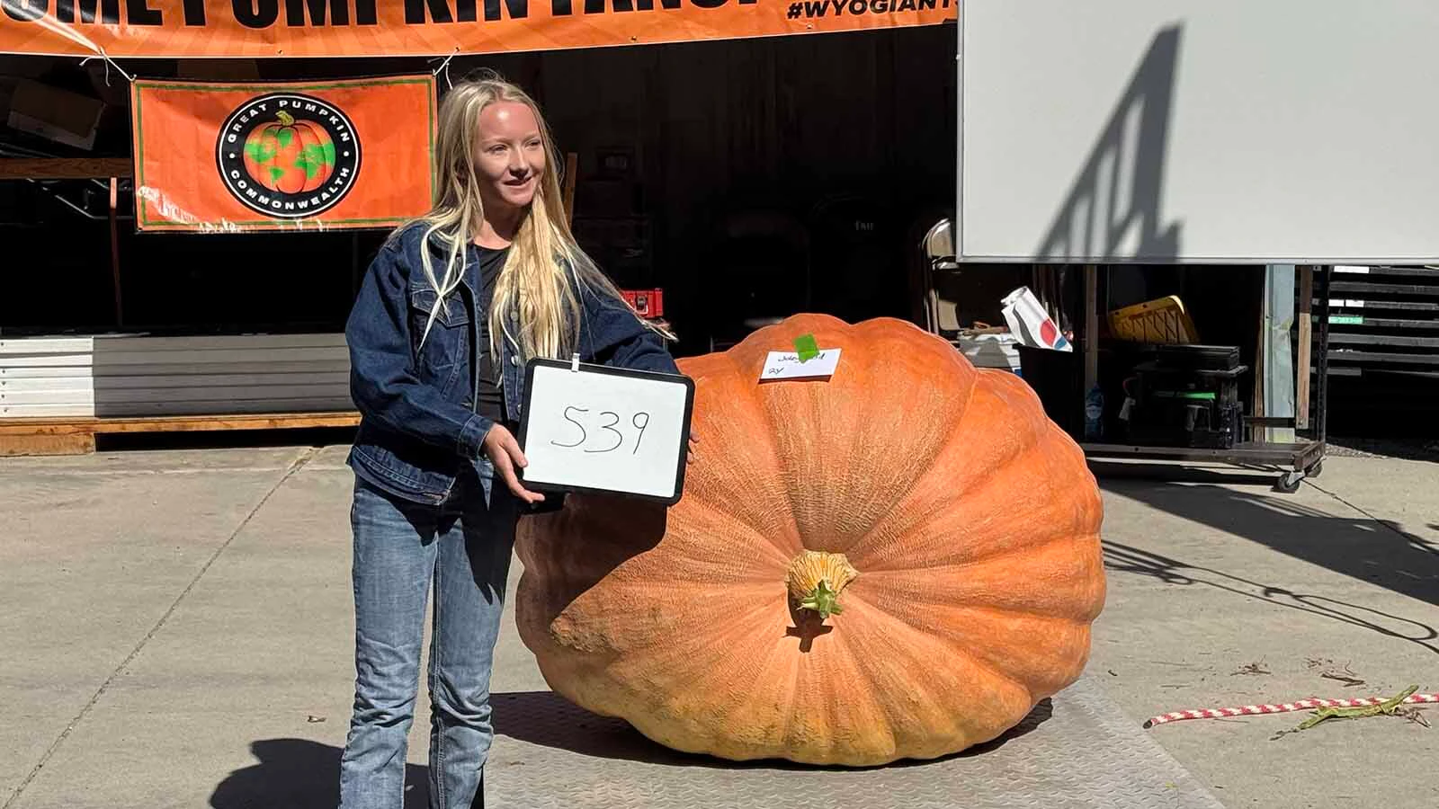 Joley Reed, 12, with her 539-pound pumpkin, "Miss Katniss Everdine," at the 2026 Wyoming State Champion Weigh-off and Pumpkin Drop in Worland. Reed's pumpkin won the Youth Giant division.