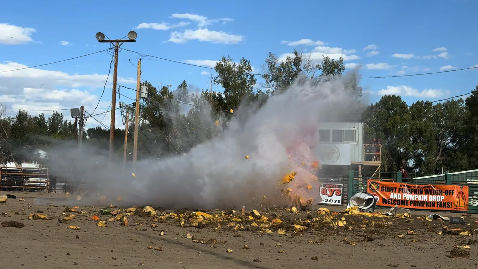 A 1,551-pound pumpkin explodes after it's dropped from 200 feet in the air onto an inflatable pool Saturday, Sept. 26, 2026, at the Wyoming State Weigh-Off and Pumpkin Drop in Worland.