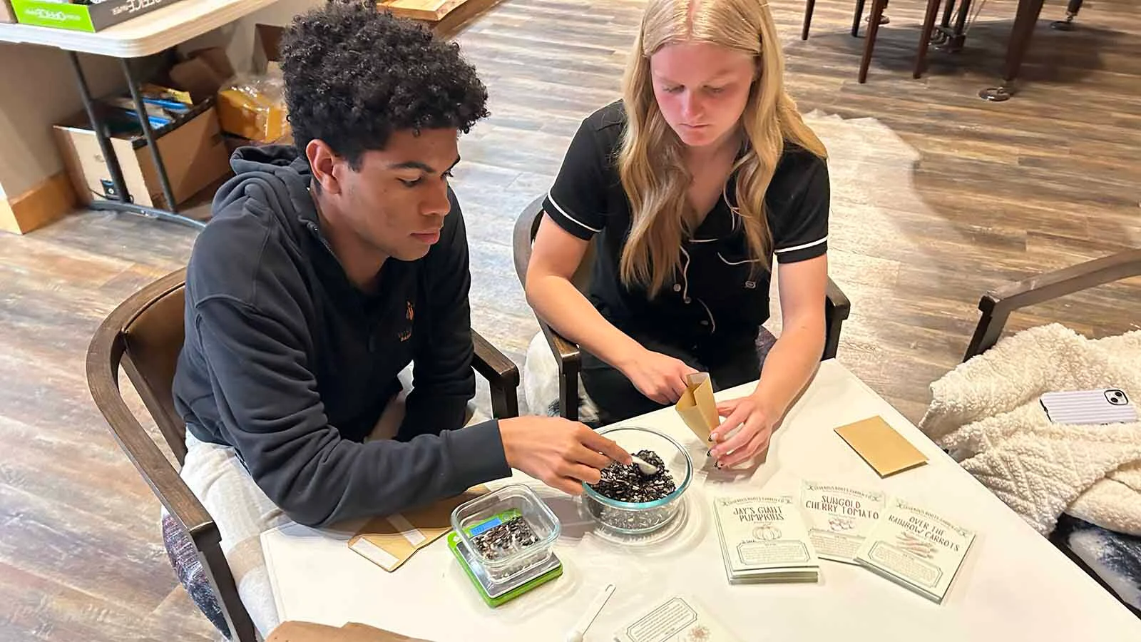 The Generous Roots Garden Co. depends on volunteers to fill their seed packets each year.  Janet Hofmann enlists the help of her children, Derrik Hackbarth and Kinlee Hofmann, to pack seeds in Worland. These seeds are each specifically selected to grow well in Wyoming’s unique climate, especially in the Bighorn Basin.