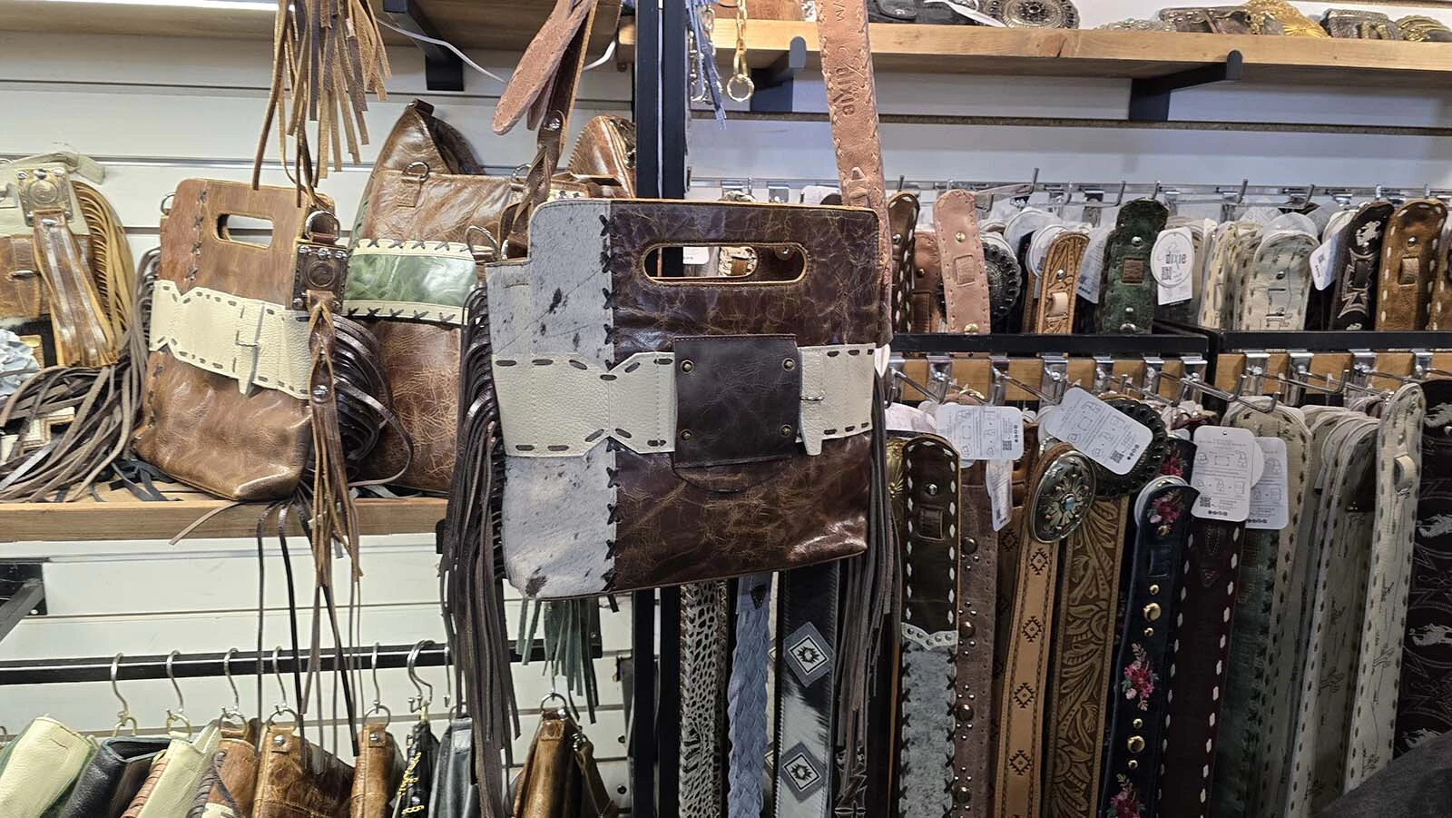 A set of four snaps on the front of this purse are ready and waiting to receive any one of dozens of distinctive patches. Next to the purse are also a series of different belts that can become the purse's strap. The system creates a lot of customizability that's made the accessories internationally popular.