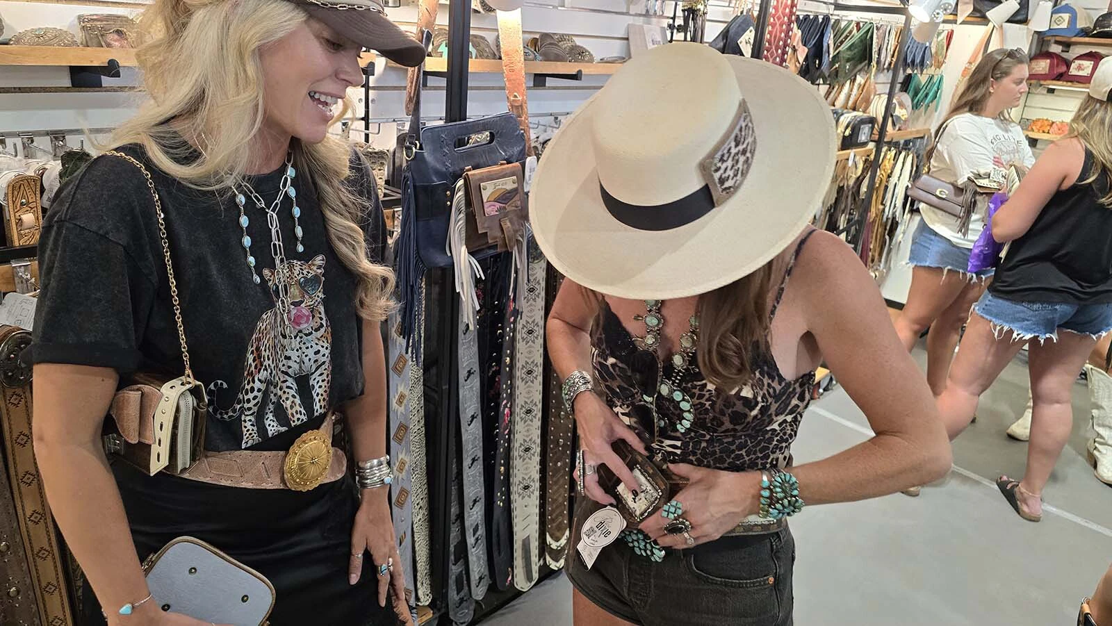 Dixie Berger watches as her friends tries on one of her newest belts.