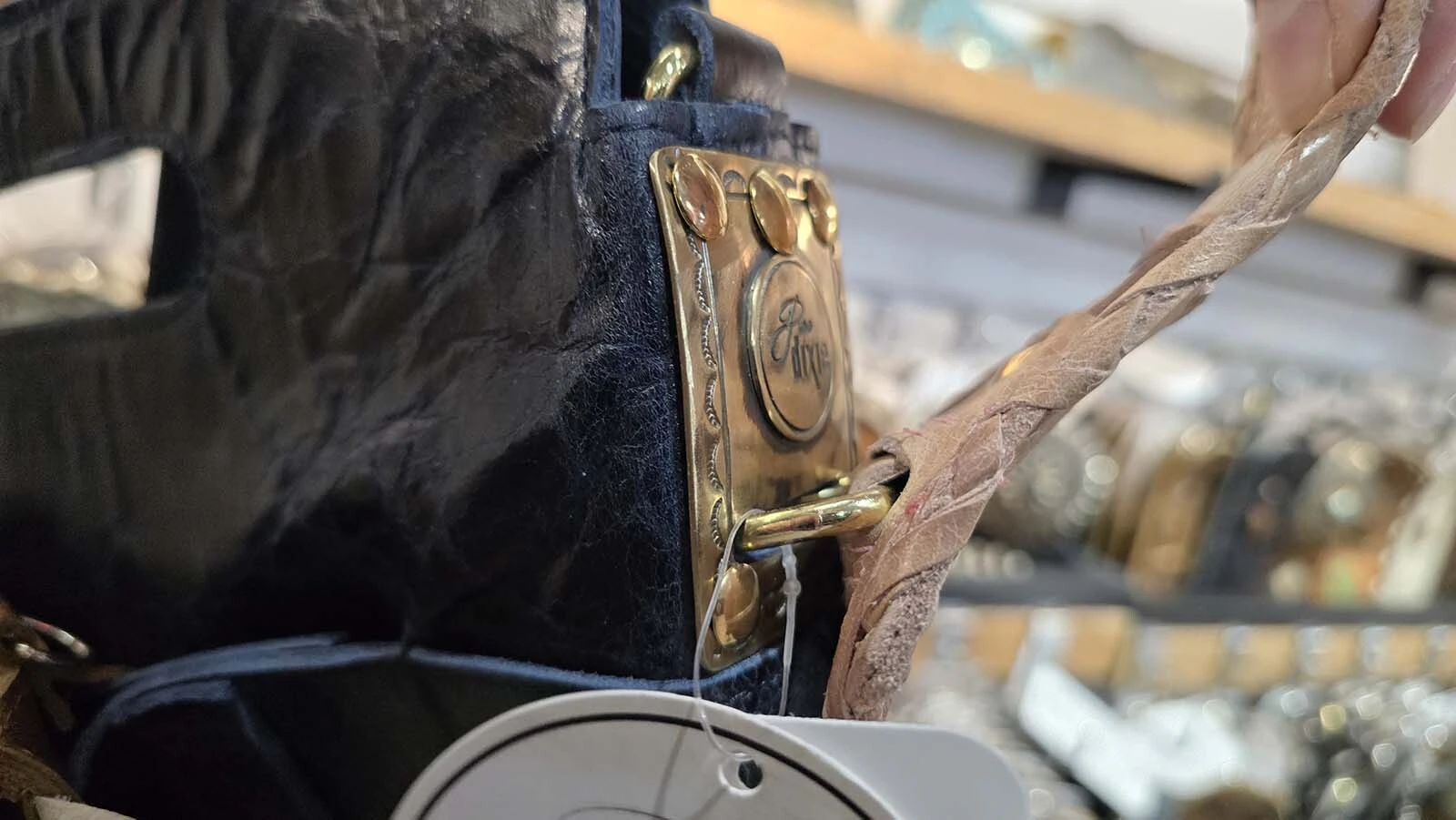 Her husband's D-ring system allows different belts to become a purse strap, allowing customers to choose their own looks for the same base purse.