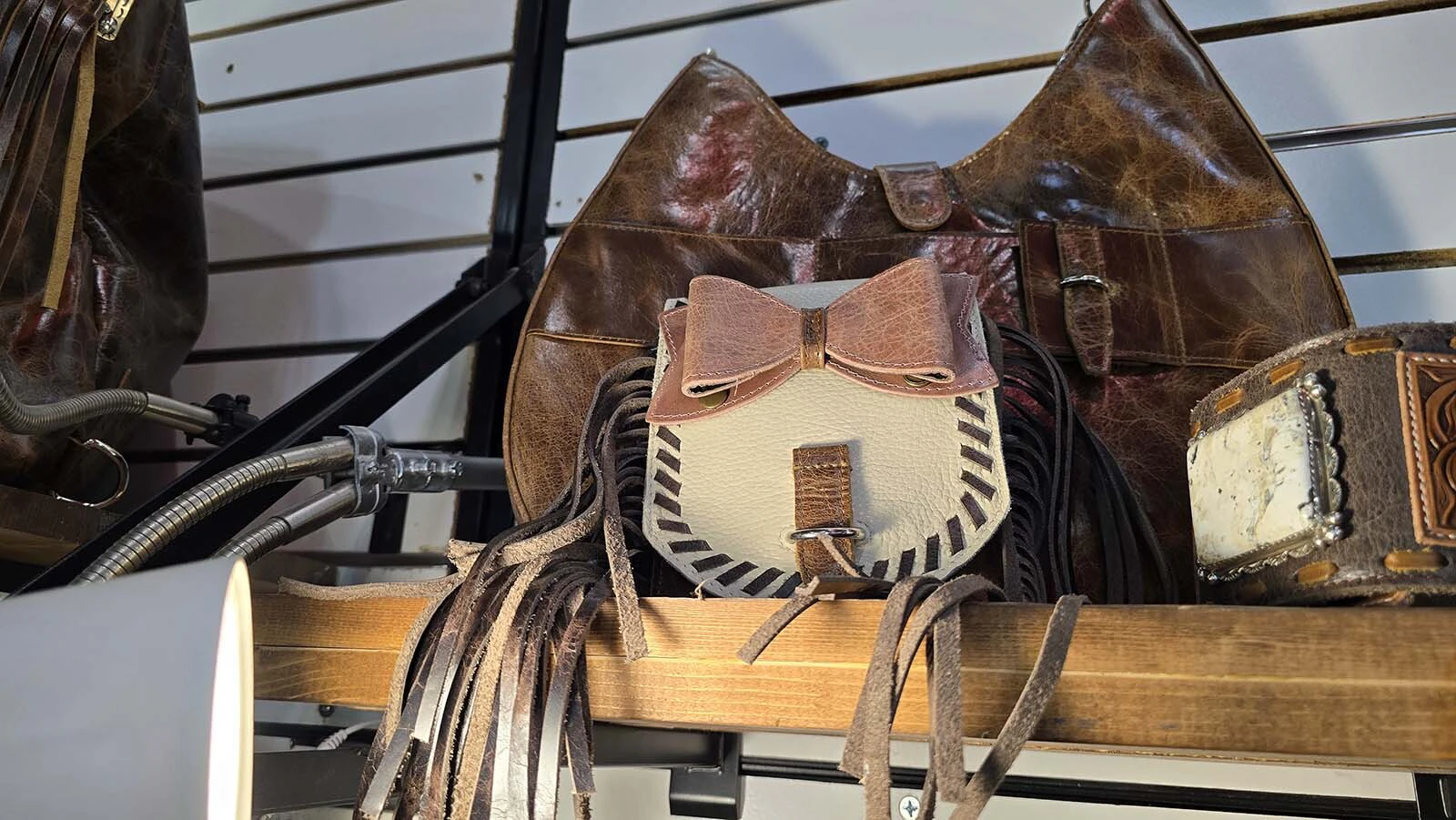 A Pure Dixie purse with a sidewinder bag and a removable pink bow patch.