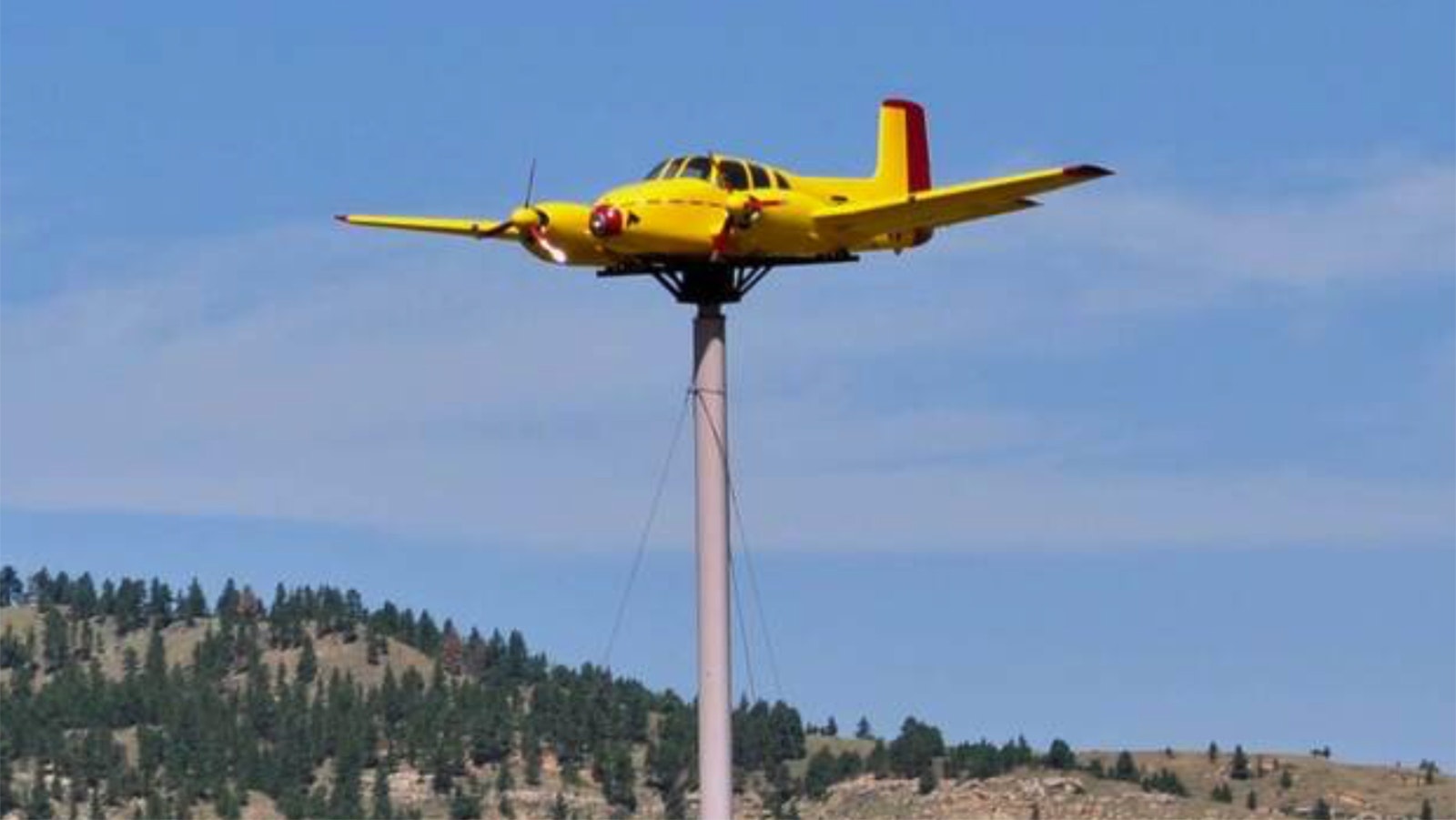 The Quaal Windsock is a 1950s Beechcraft Twin Bonanza on top of a 70-foot pole outside Sundance, Wyoming, along Interstate 90.